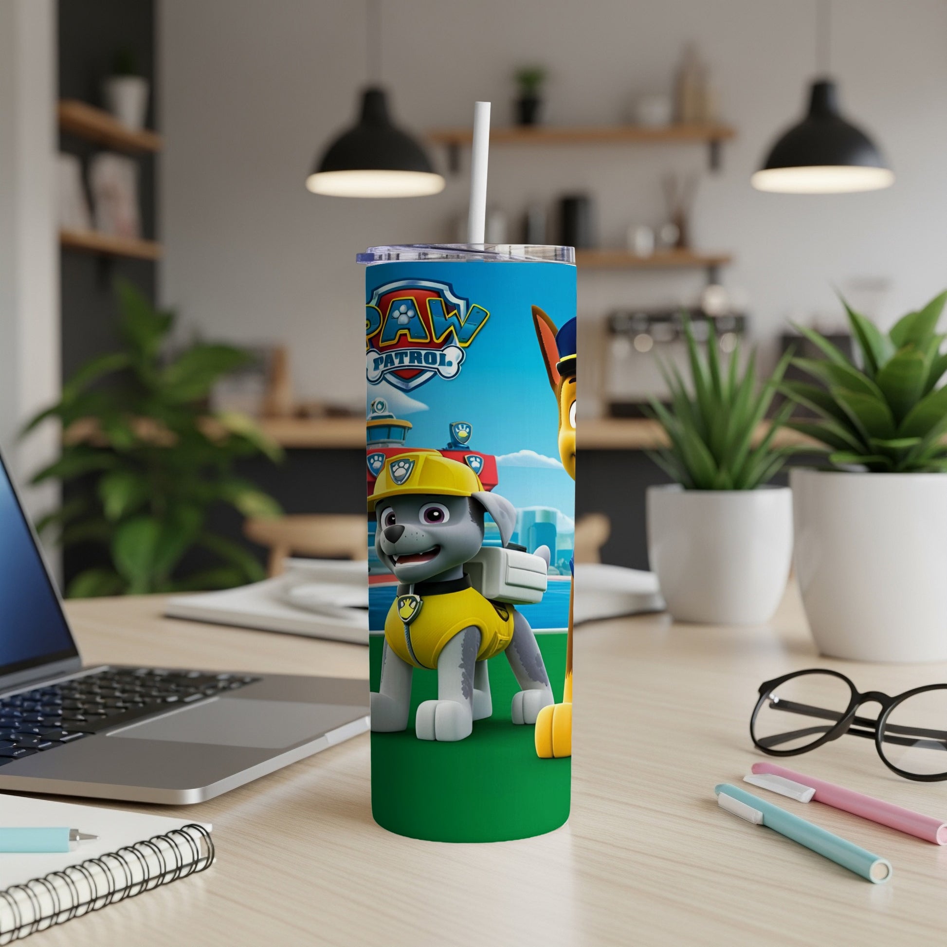 Paw Patrol character on a green background, with a laptop and desk supplies.