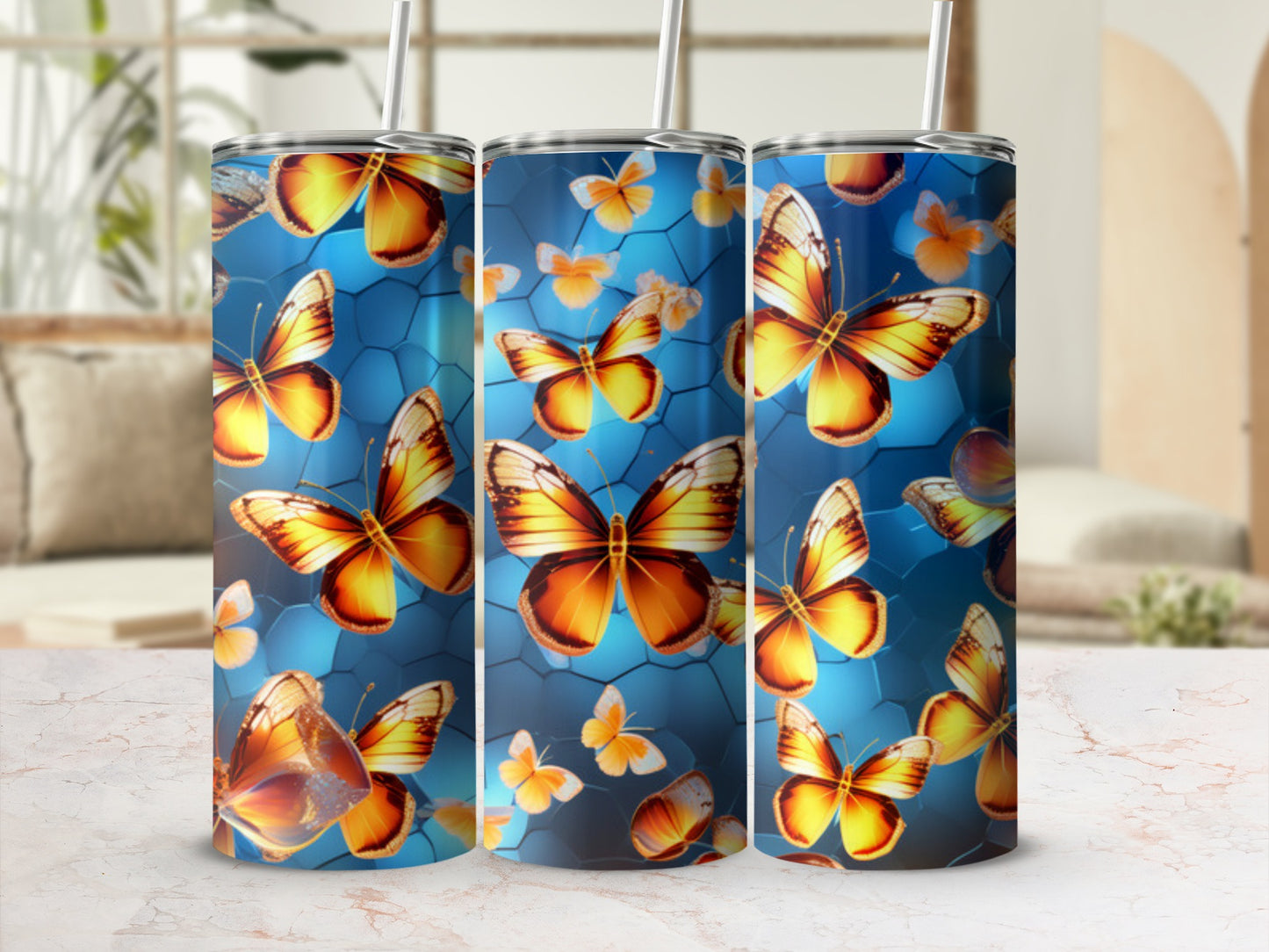 Three tumblers featuring golden butterflies on a blue hexagonal background.