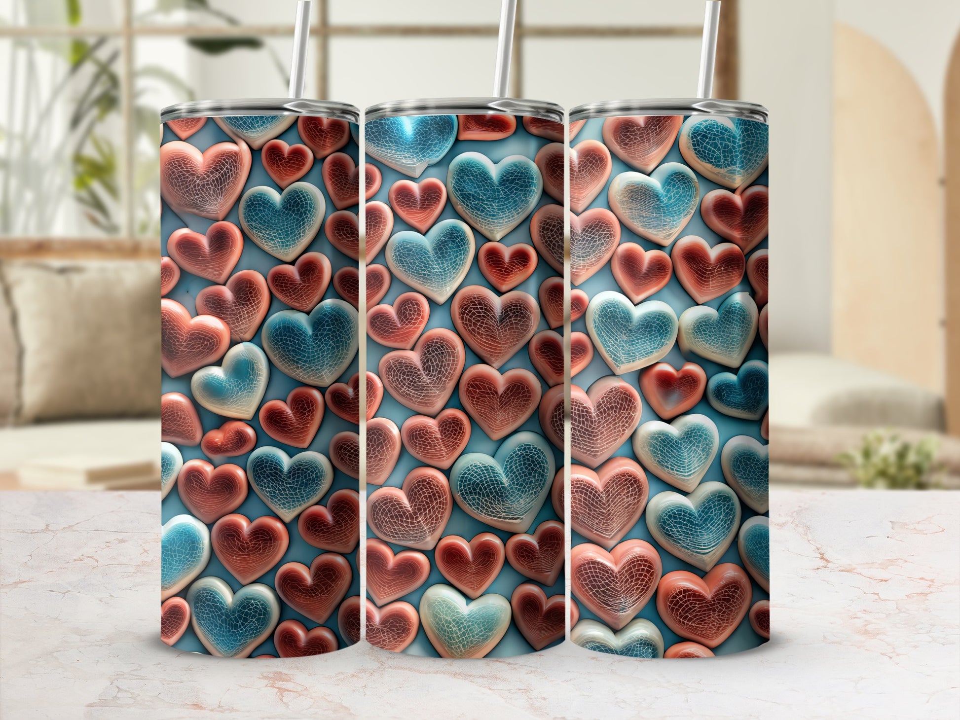 Three tumblers with textured heart patterns, displayed on a marble surface.