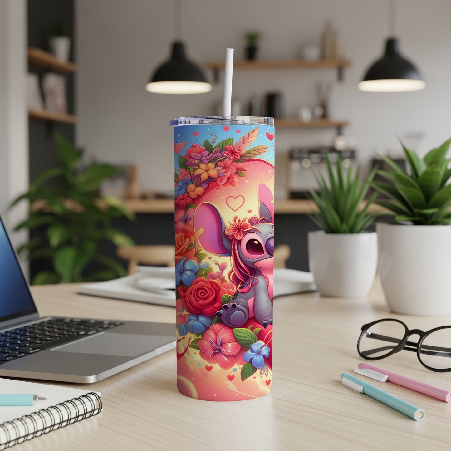 Pink Stitch character on a floral patterned tumbler with a straw.