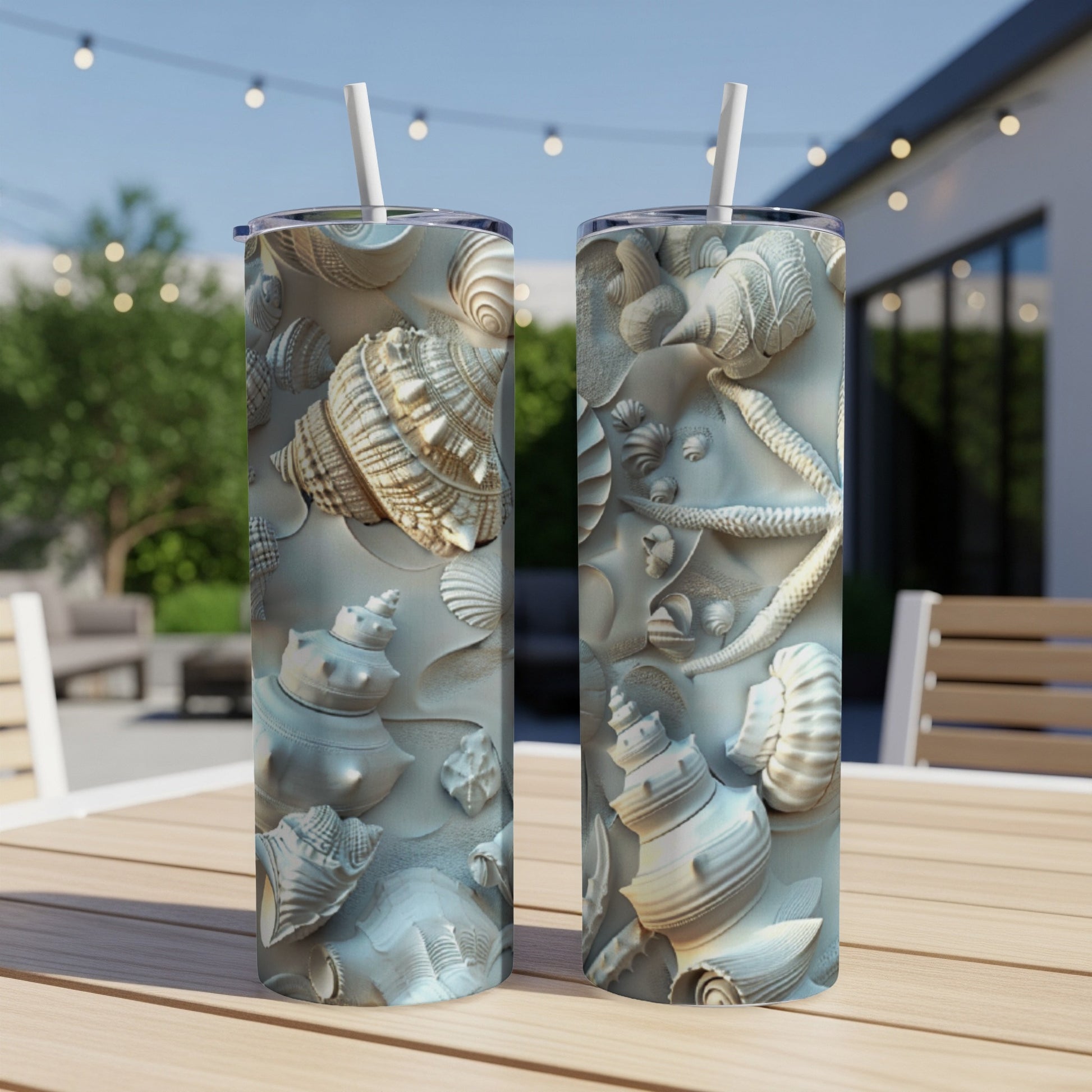 Two tall tumblers with raised seashell and starfish designs.
