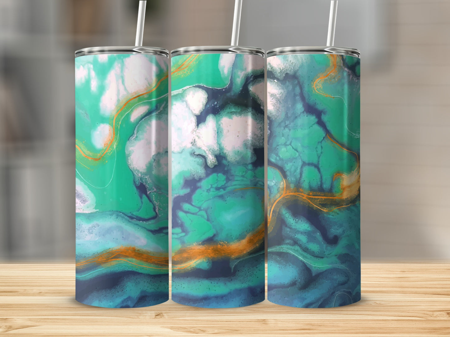 Three tumblers with a swirling green, blue, and gold abstract design on a wooden surface.