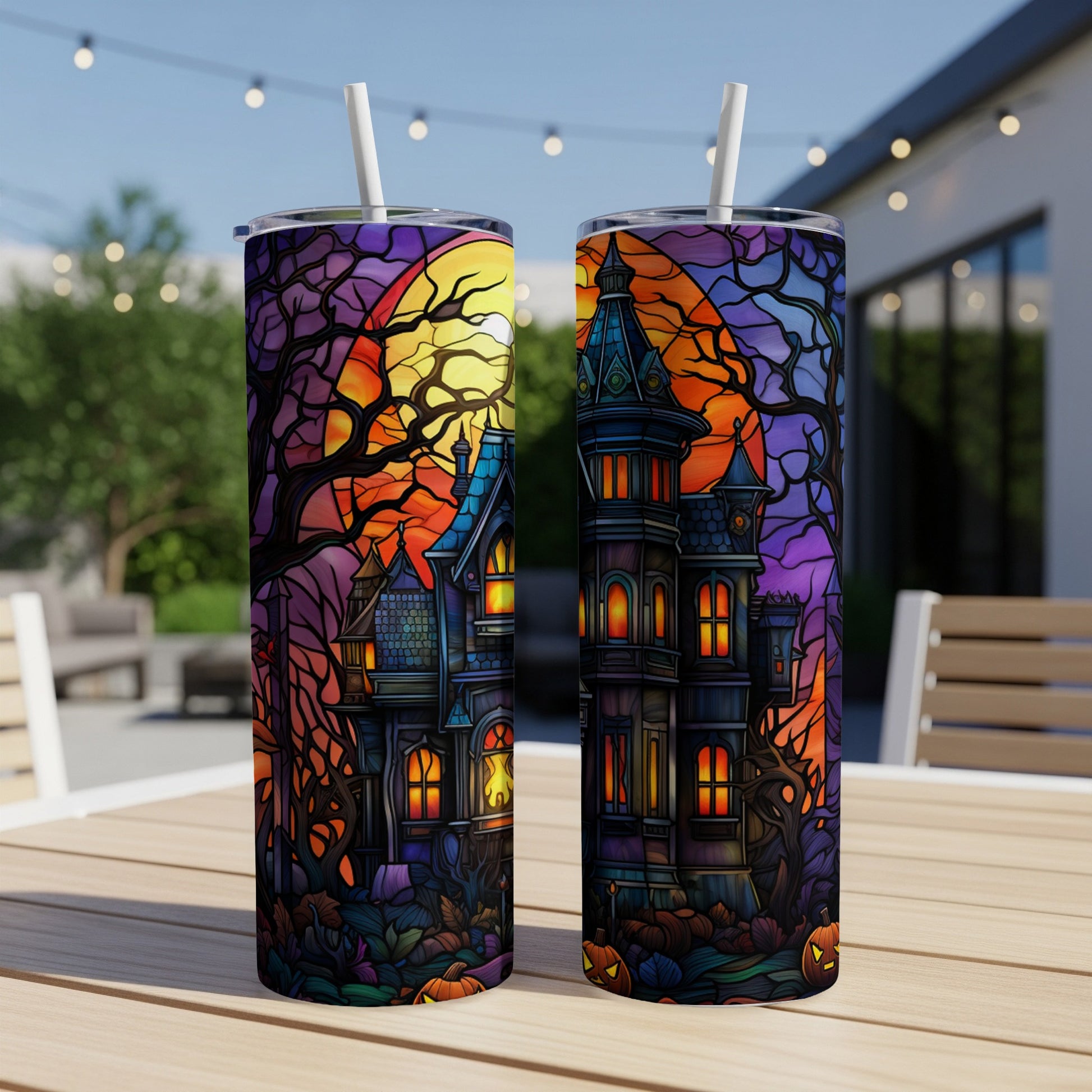 Two tumblers with a spooky haunted house and moon design.