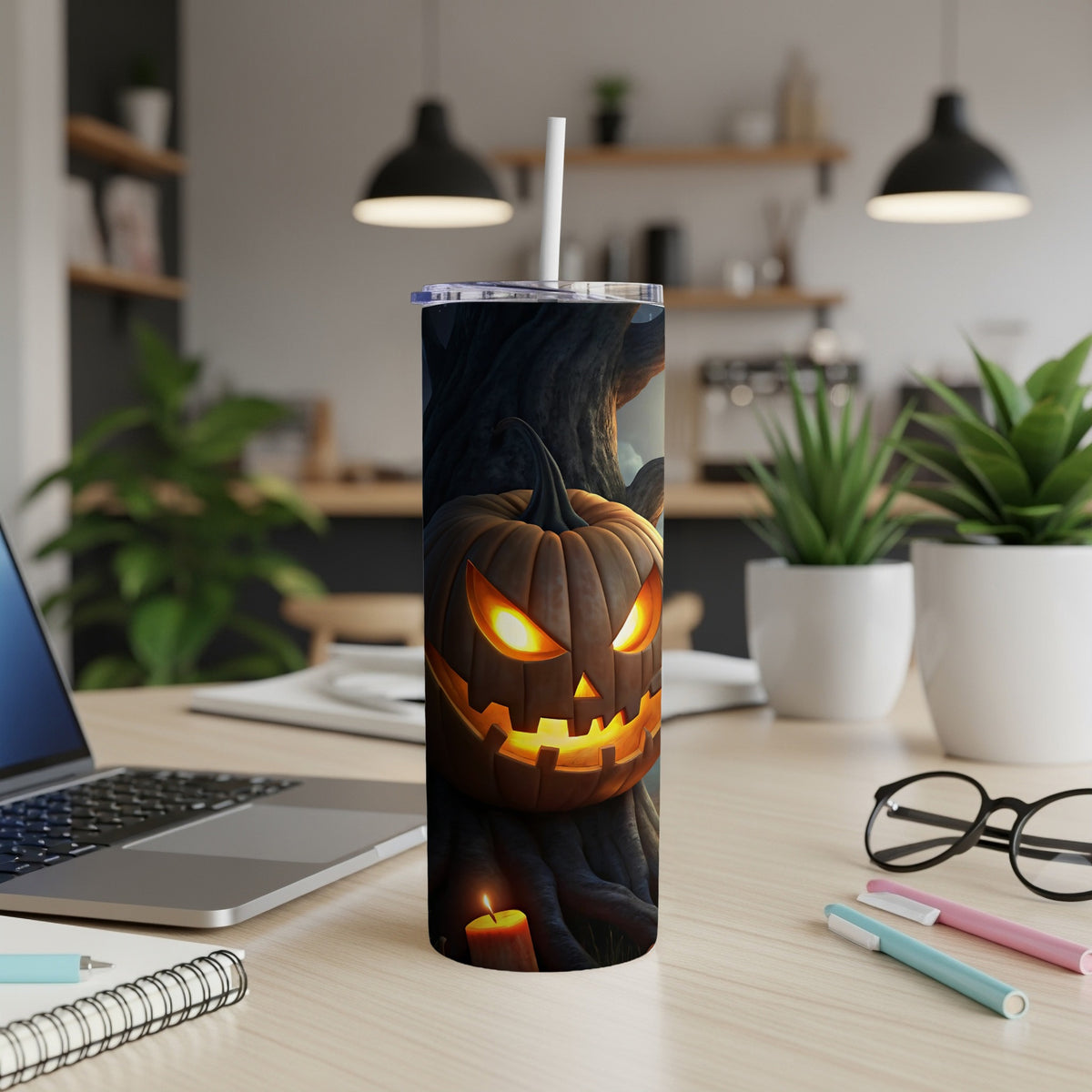 Tumbler with carved jack-o'-lantern on a dark, spooky background with a lit candle.