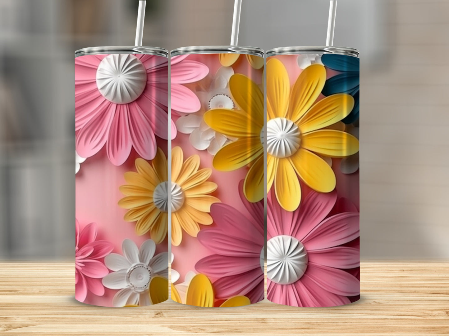 Three tumblers with pink, yellow, and white flower designs.