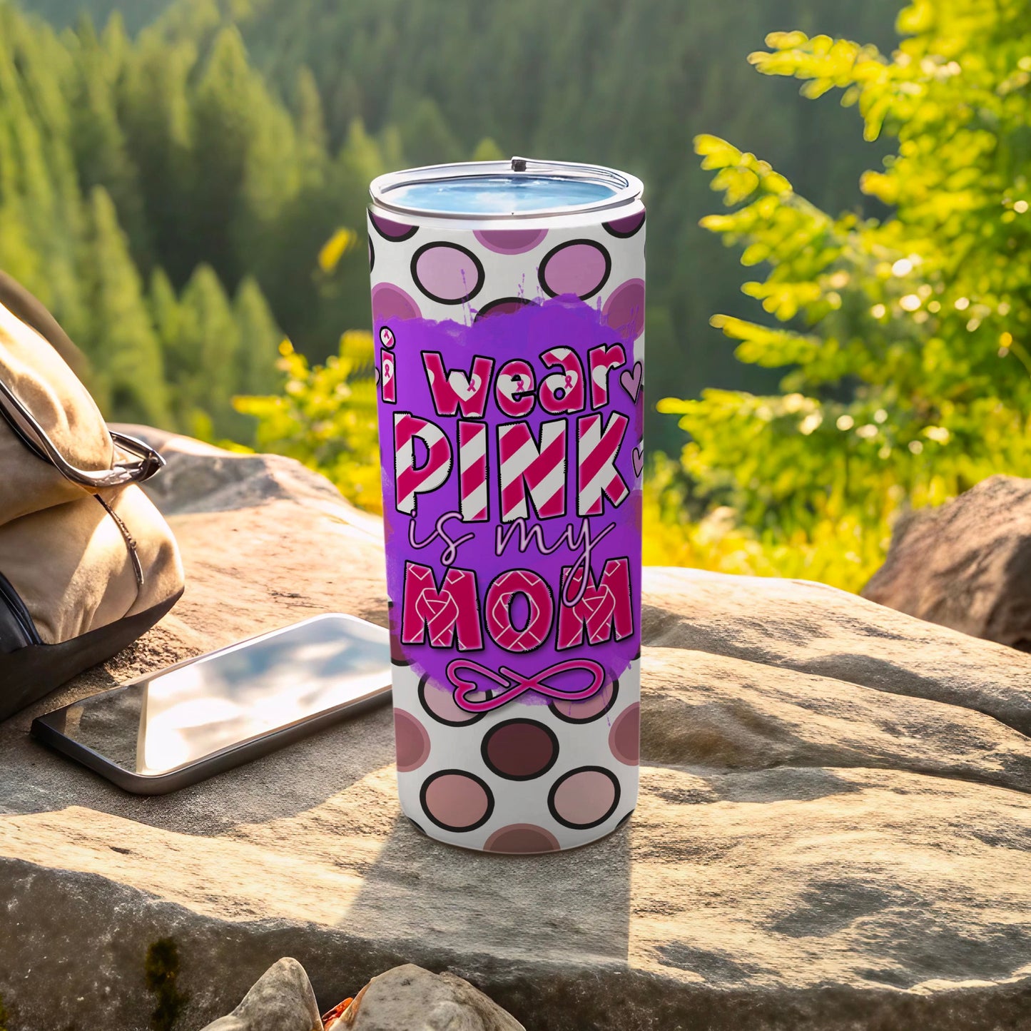 Pink tumbler with "I wear pink is my mom" text on polka dot background.