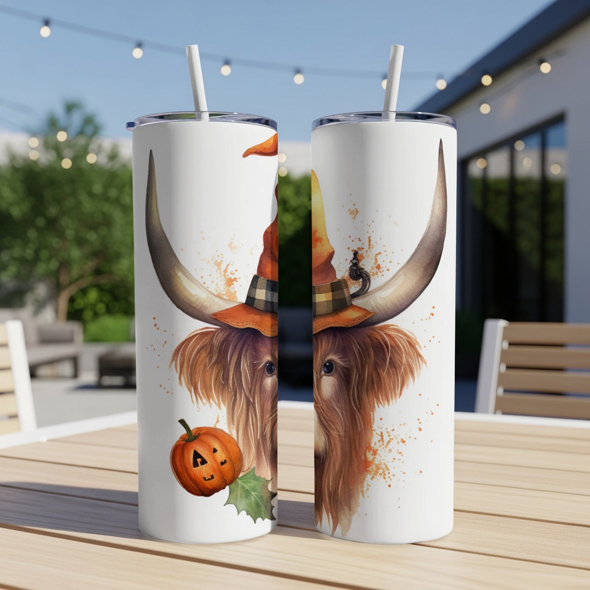 Highland cow wearing a witch hat and Halloween pumpkin on a tumbler.
