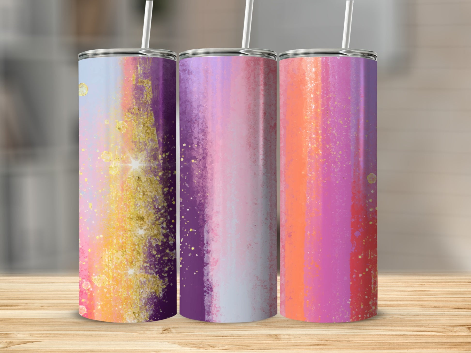 Three tumblers with abstract colorful watercolor stripes and gold glitter accents.