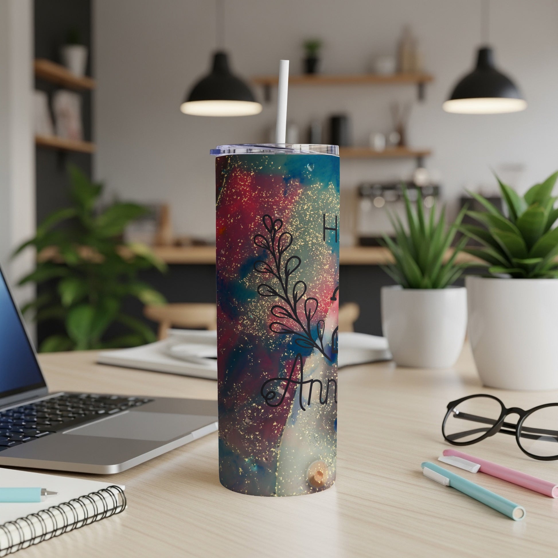 Glittery tumbler with "Happy Anniversary" text on a desk.