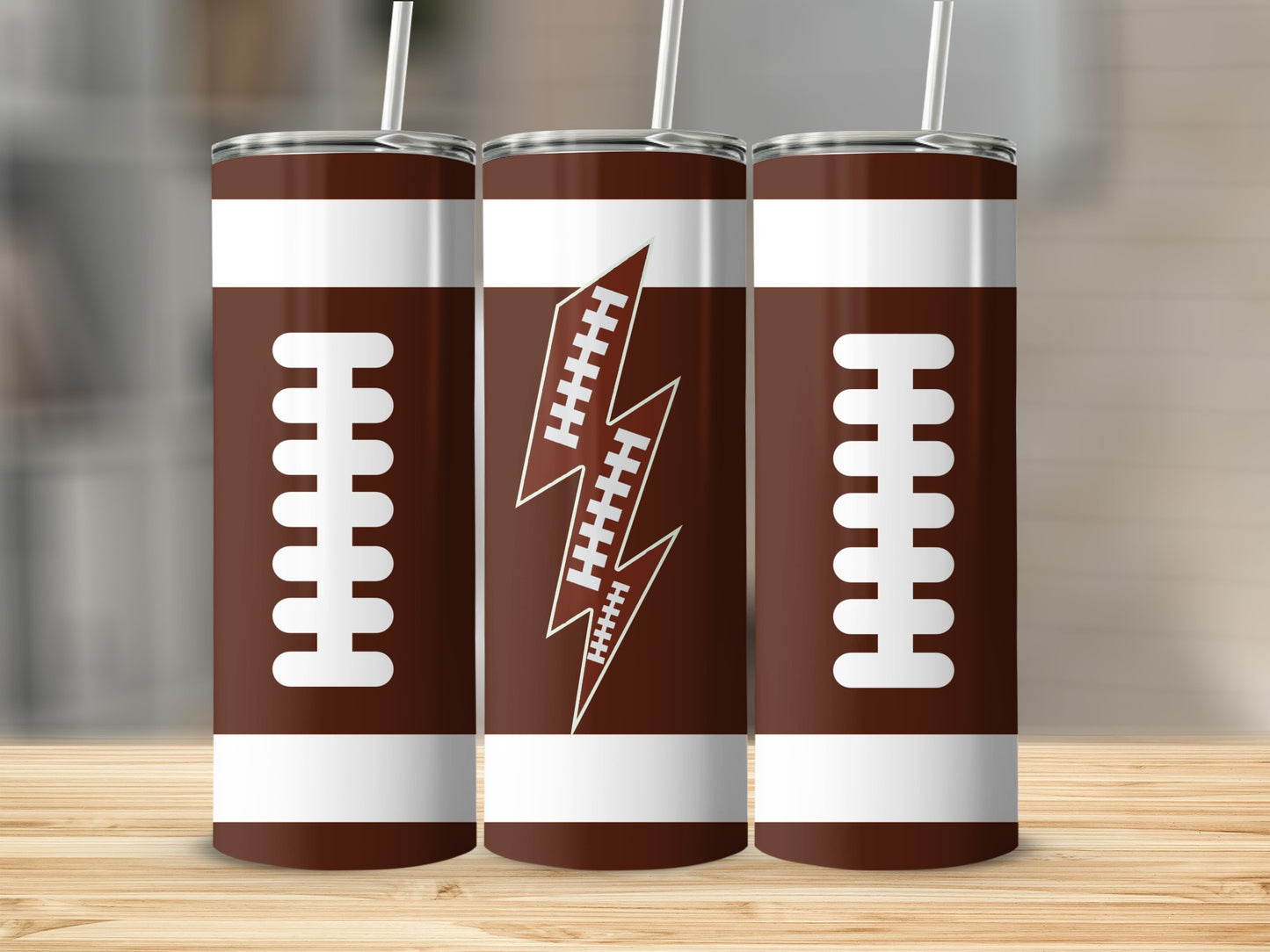 Three brown football-themed tumblers with white laces and lightning bolt designs.