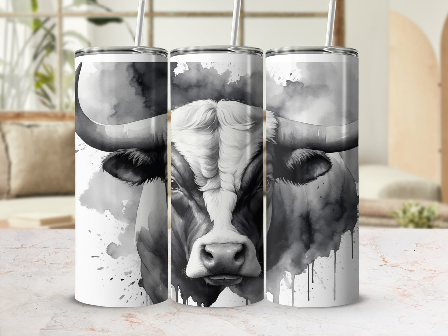 Watercolor bull portrait on three white tumblers with straws.