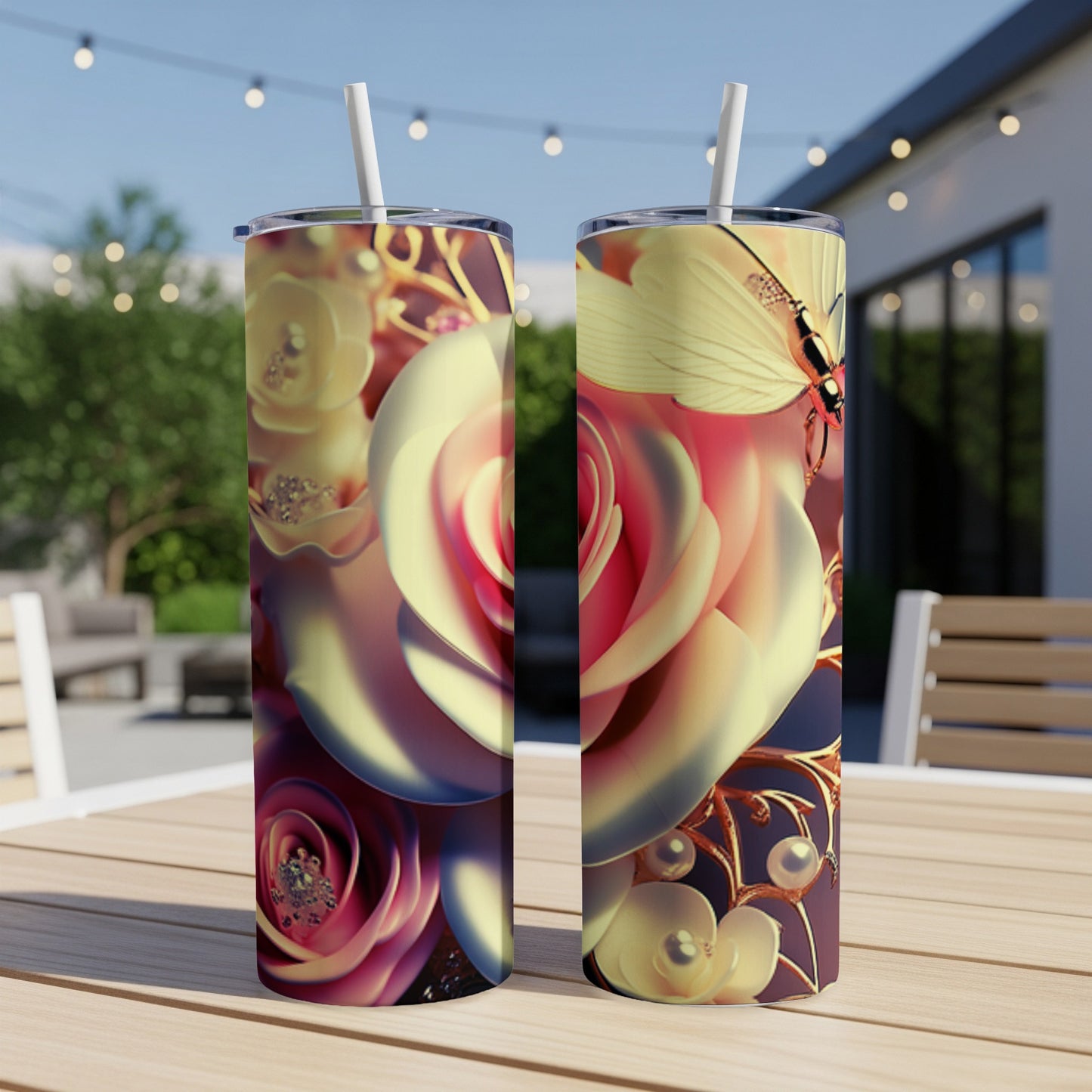 Two tumblers with a floral and butterfly design on a table outdoors.