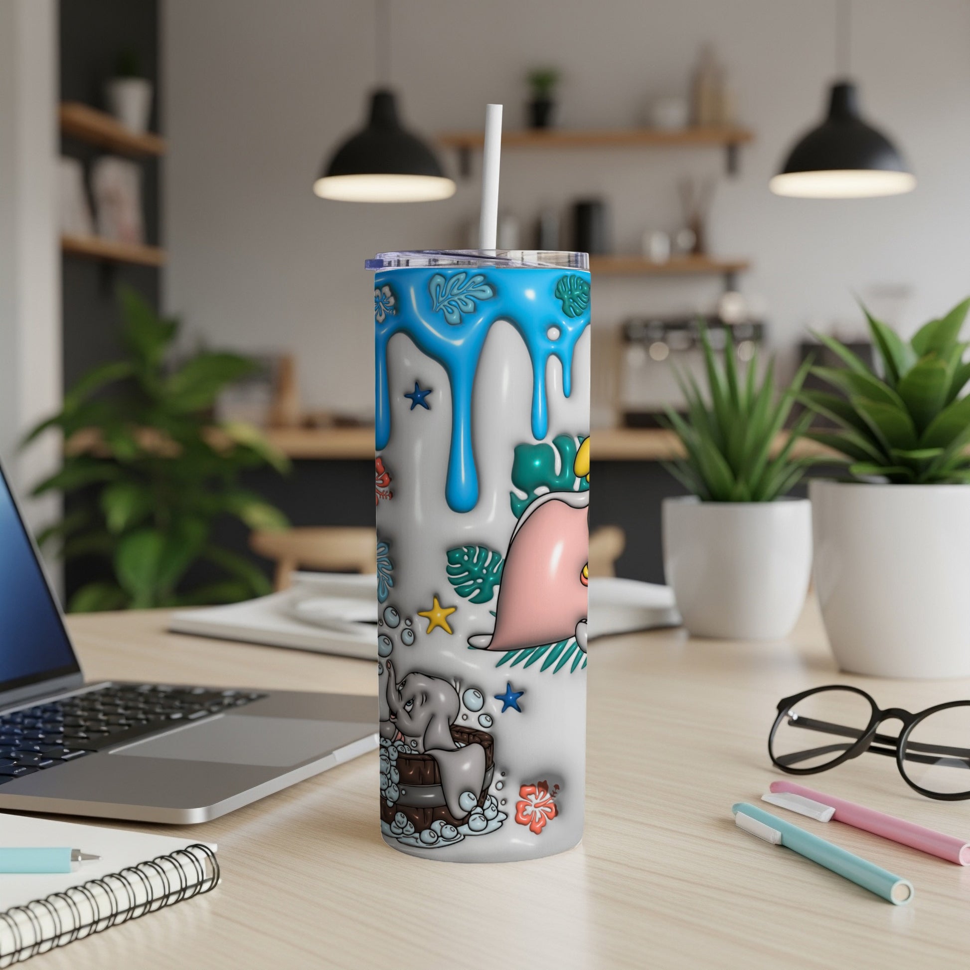 White tumbler with cartoon elephants and bubbles, on a desk.