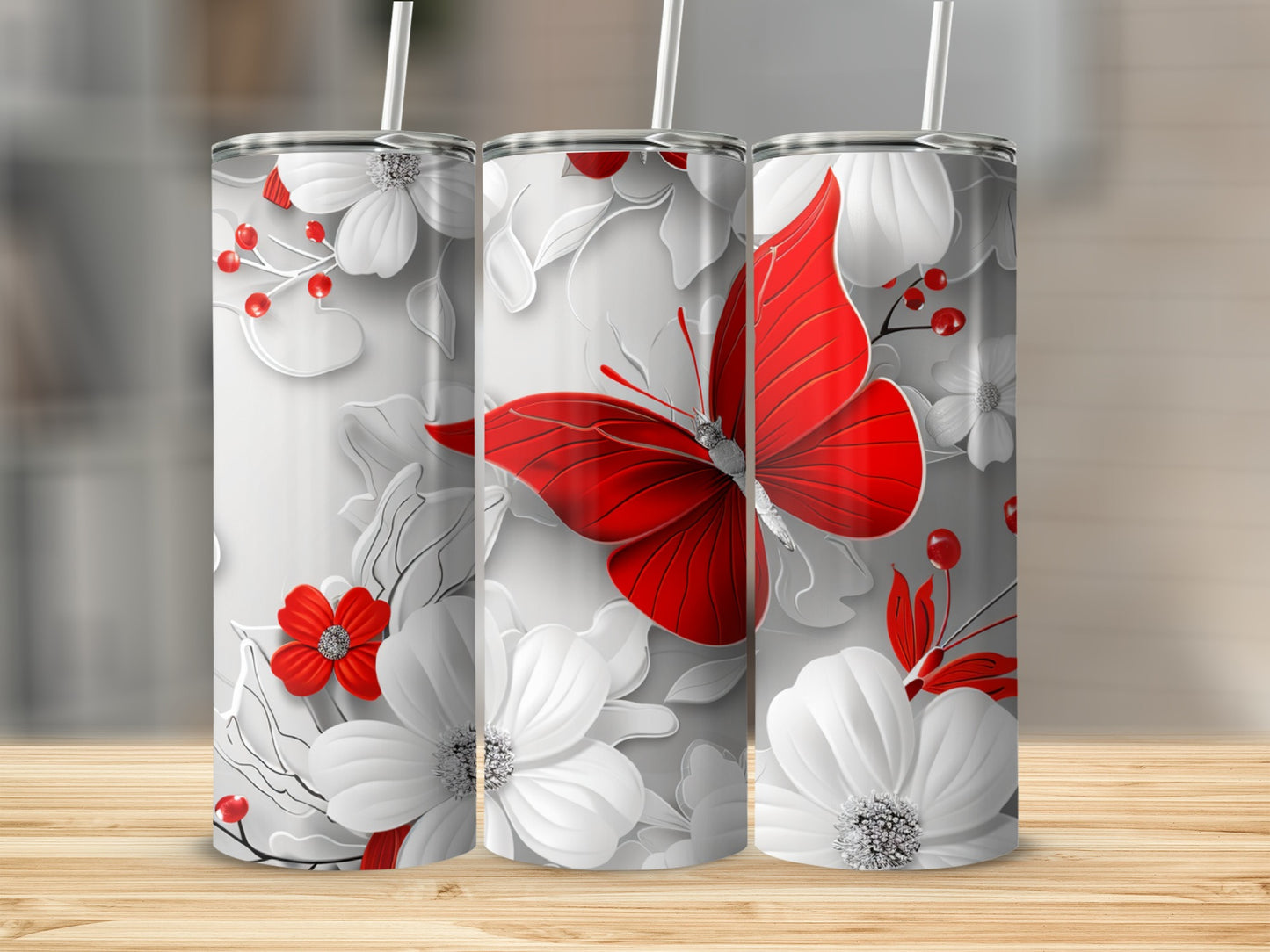 Three white tumblers with red butterfly and flower designs.