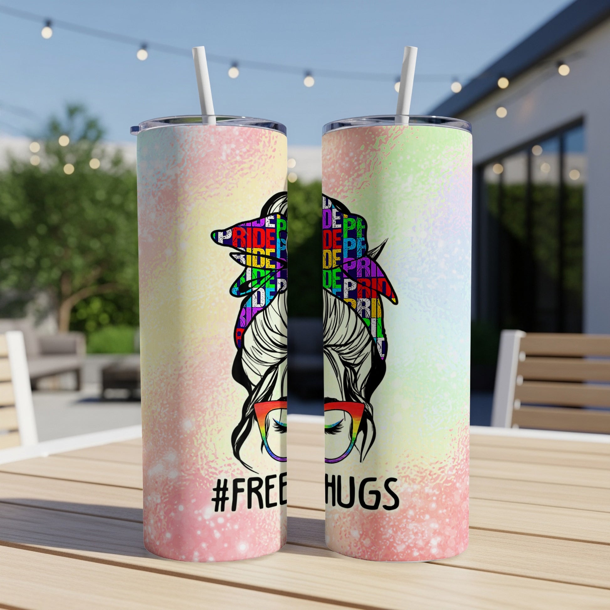 Two tumblers with rainbow "Pride" text and "#FREE HUGS" on a blurred background.
