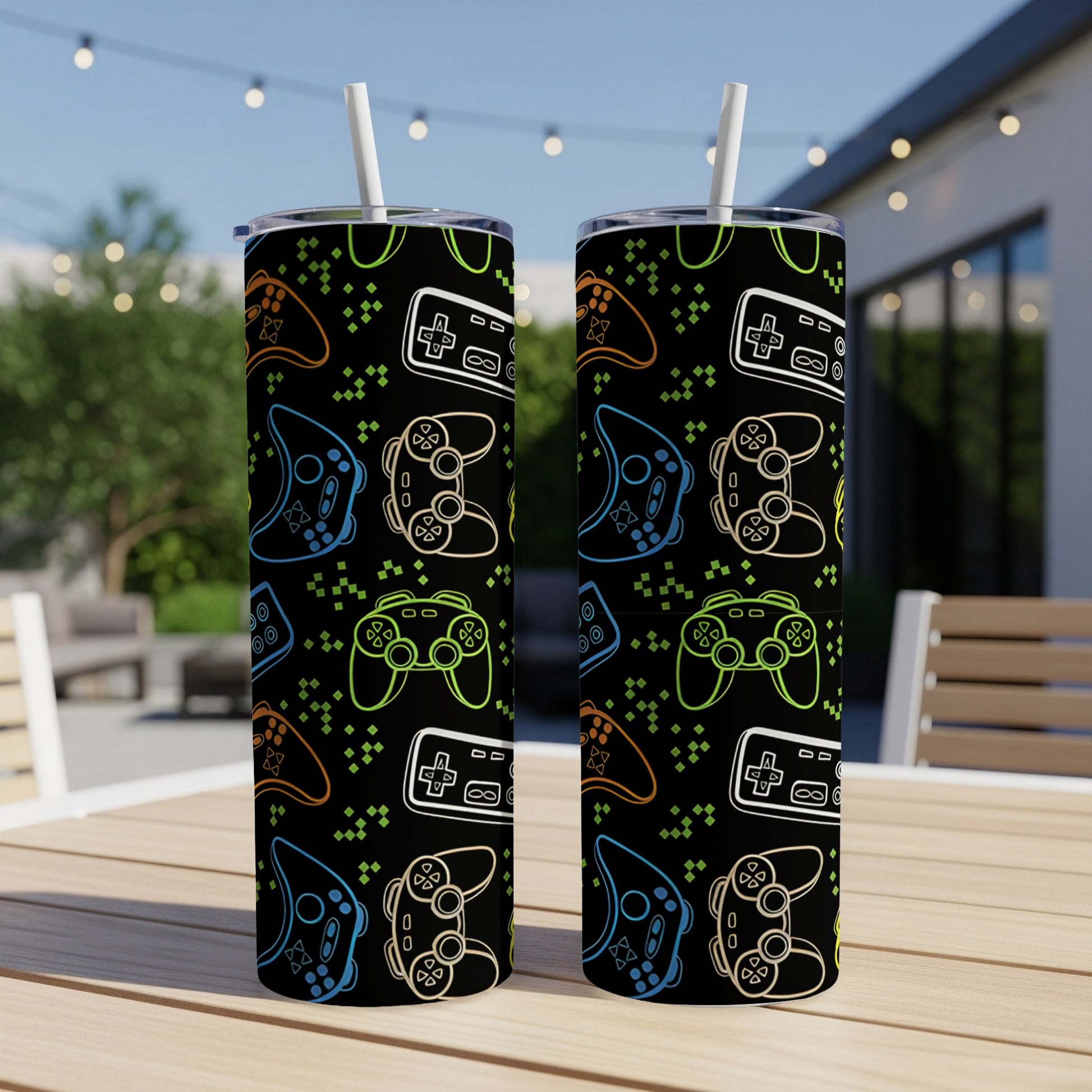 Two tumblers with a repeating pattern of colorful video game controllers on black.