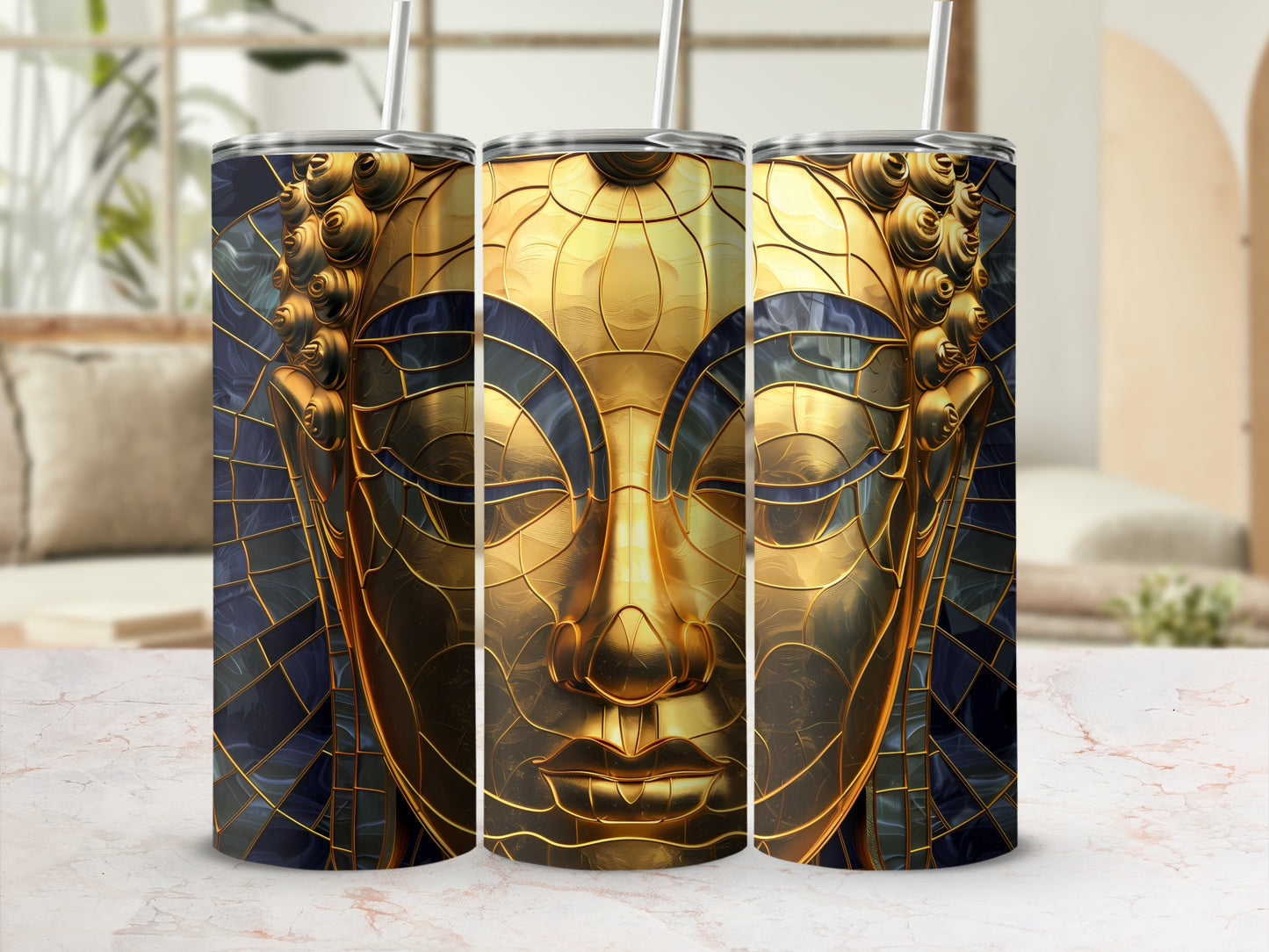 Three tumblers with gold Buddha face design and dark blue mosaic background.