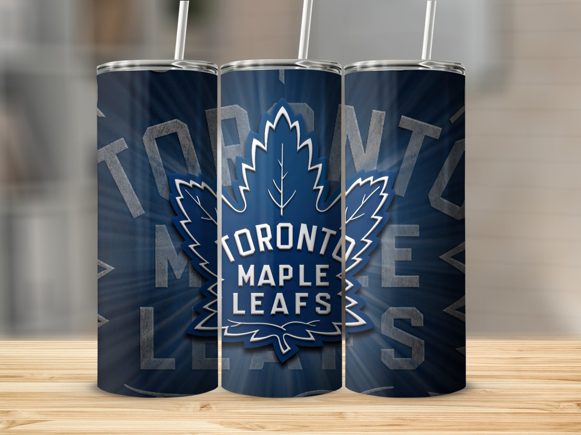 Three Toronto Maple Leafs tumblers with blue background and white maple leaf logo.