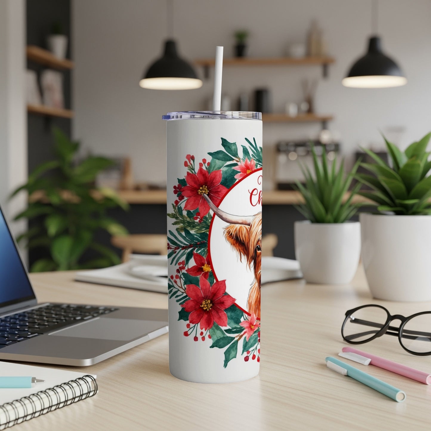 White tumbler with Highland cow and Christmas wreath, "Merry Christmas" text.