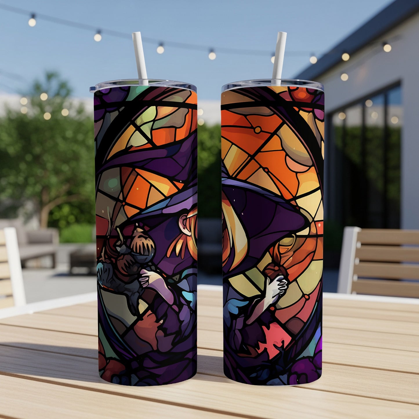 Two purple tumblers with stained glass style art of a winged figure.