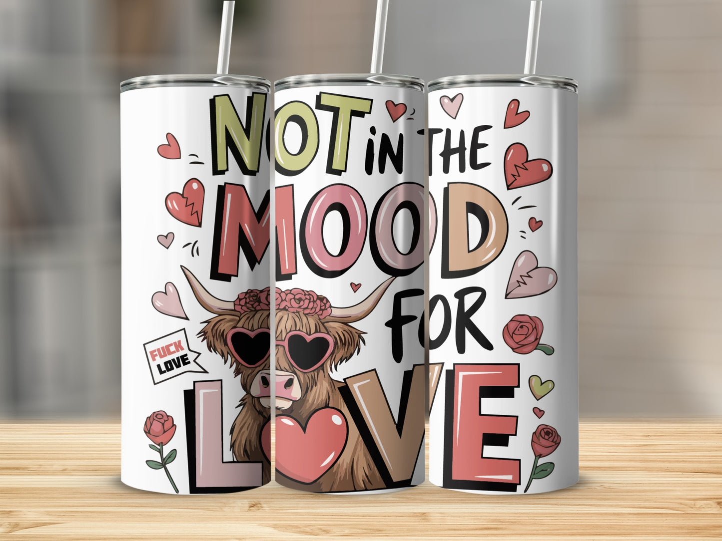 Three tumblers with "Not in the Mood for Love" text and heart and rose designs.