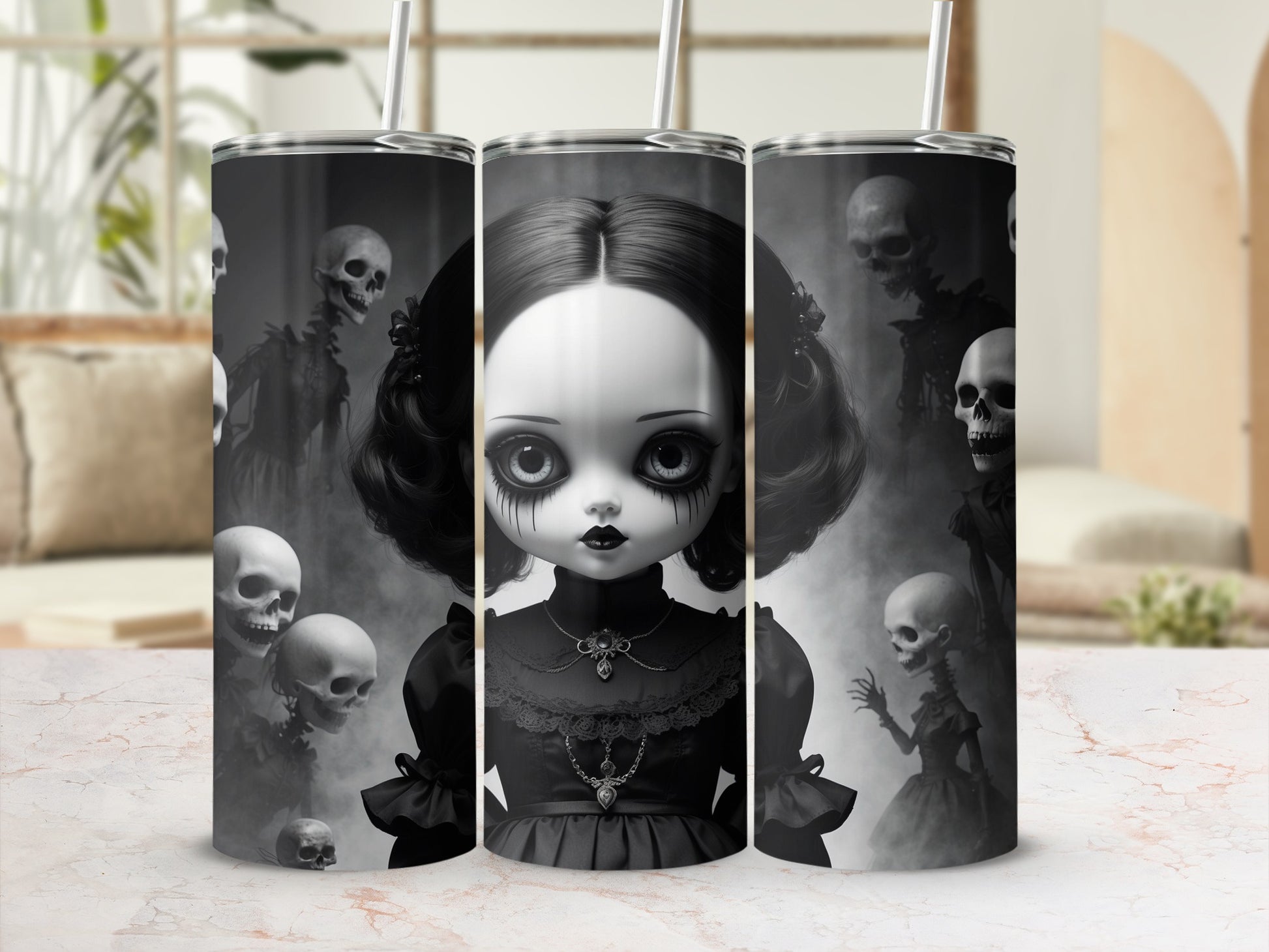 Gothic doll with skulls and spooky figures on a tumbler.