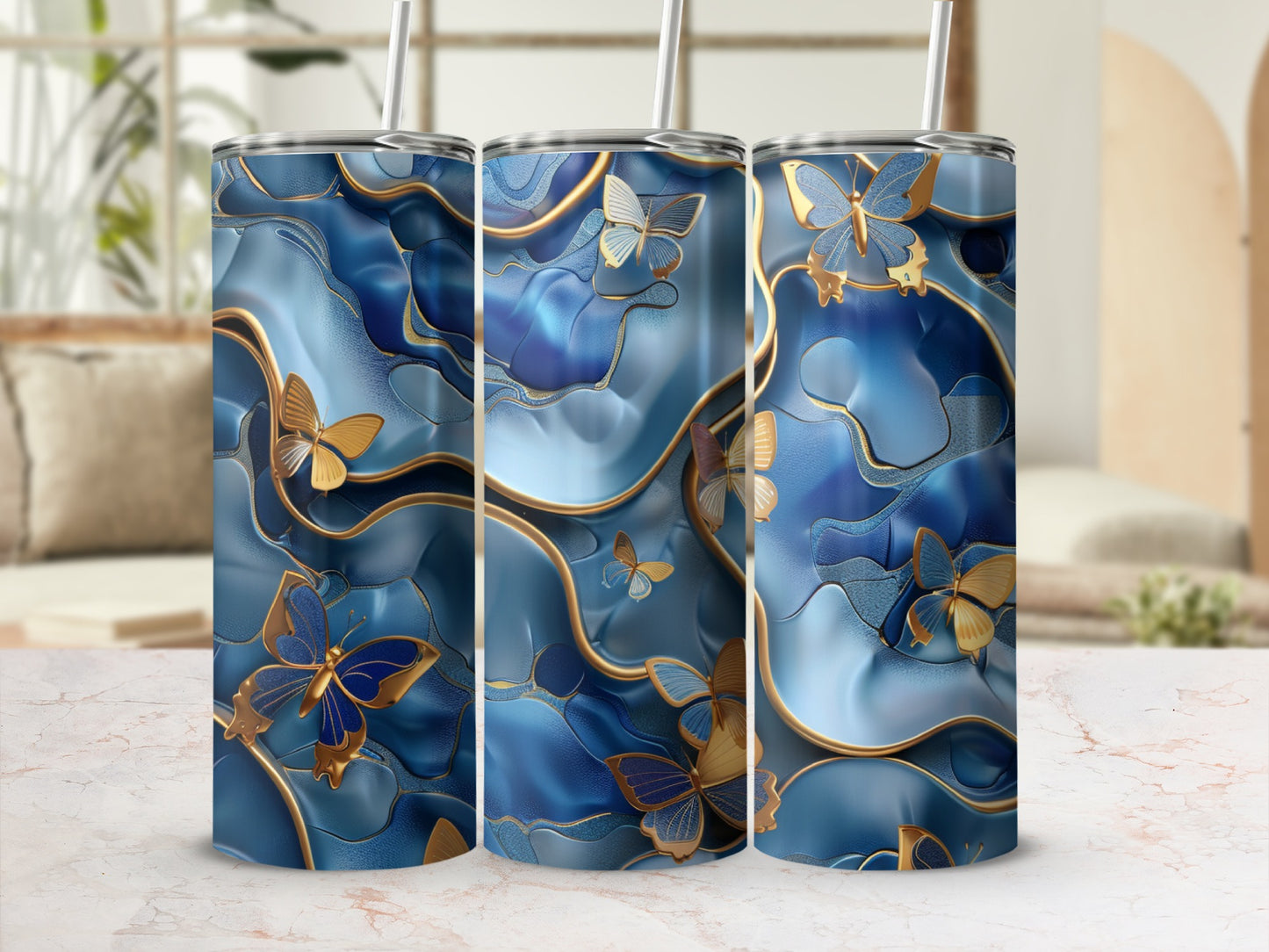 Three tumblers with a blue marbled design and gold butterflies.