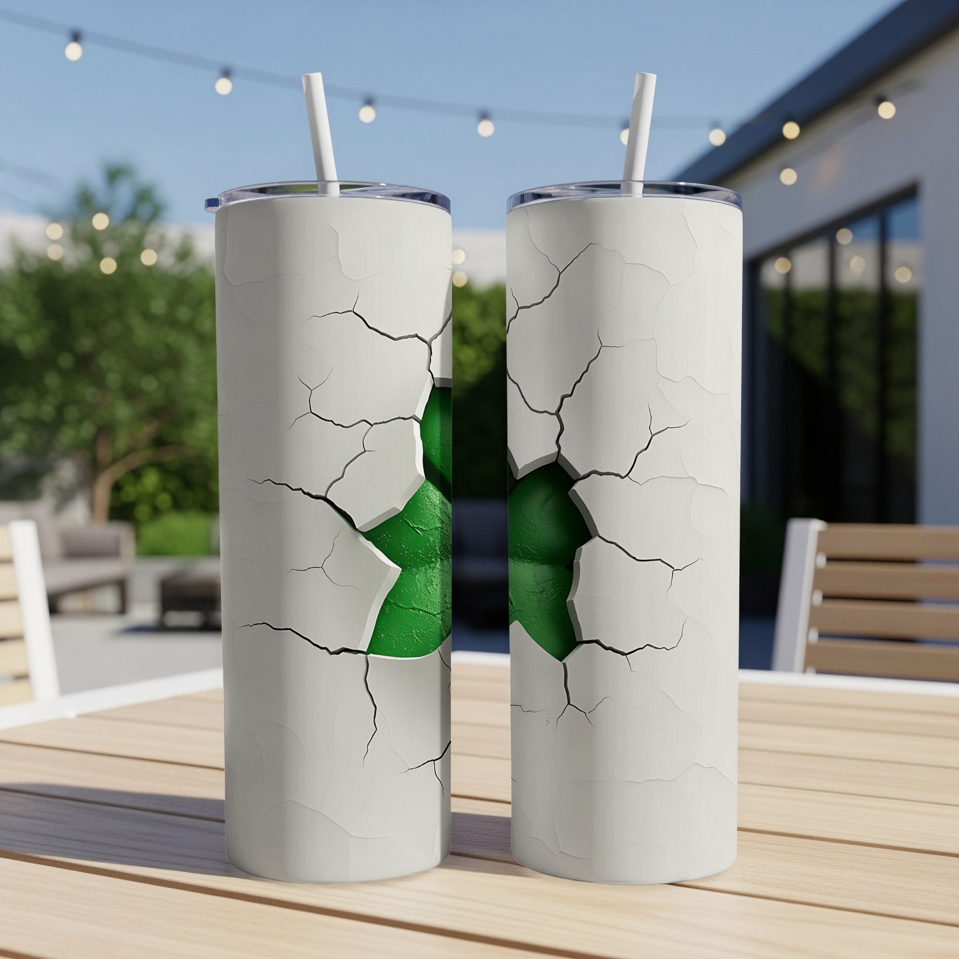 Two white tumblers with cracked designs revealing a green interior.