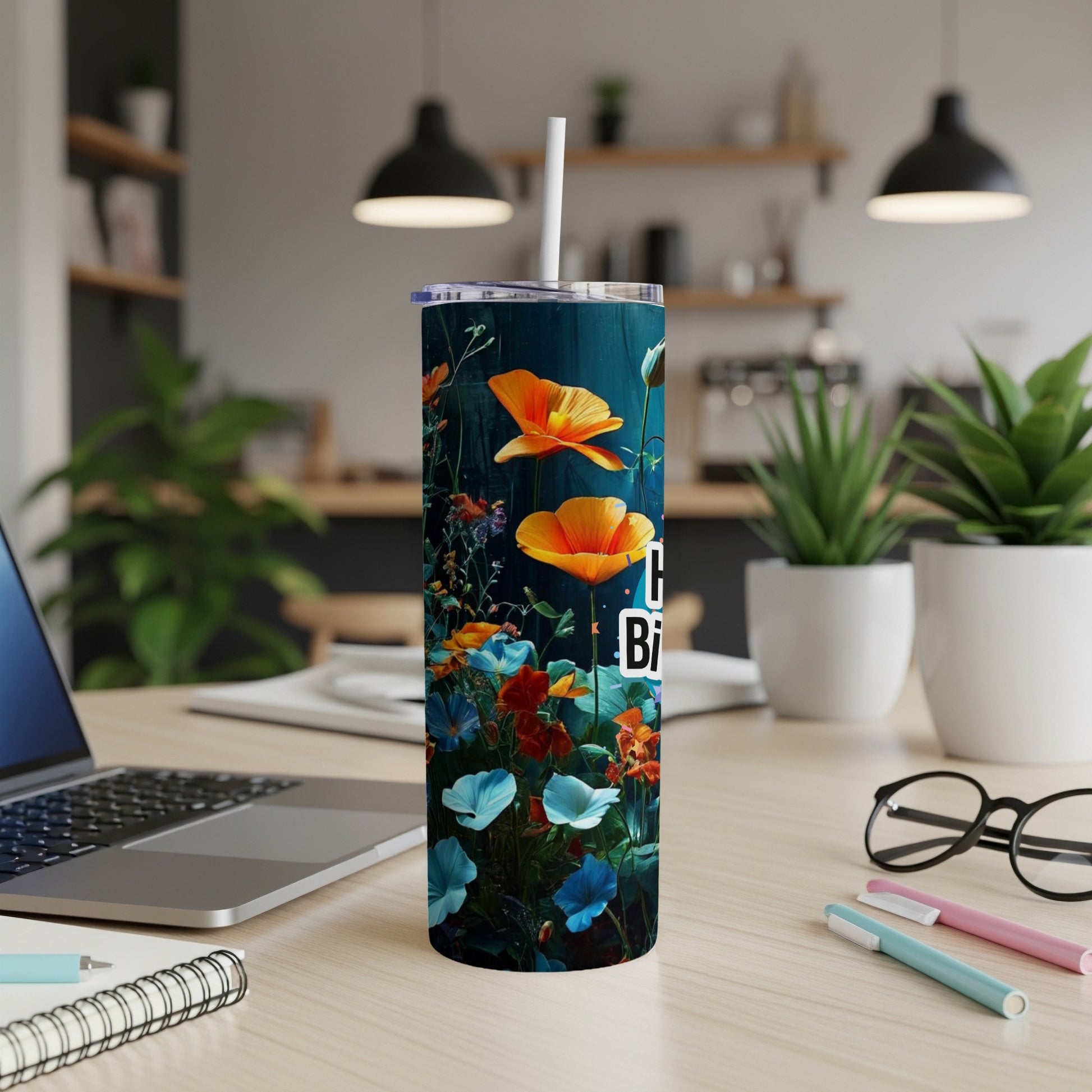 Tall tumbler with orange and blue flowers and text.