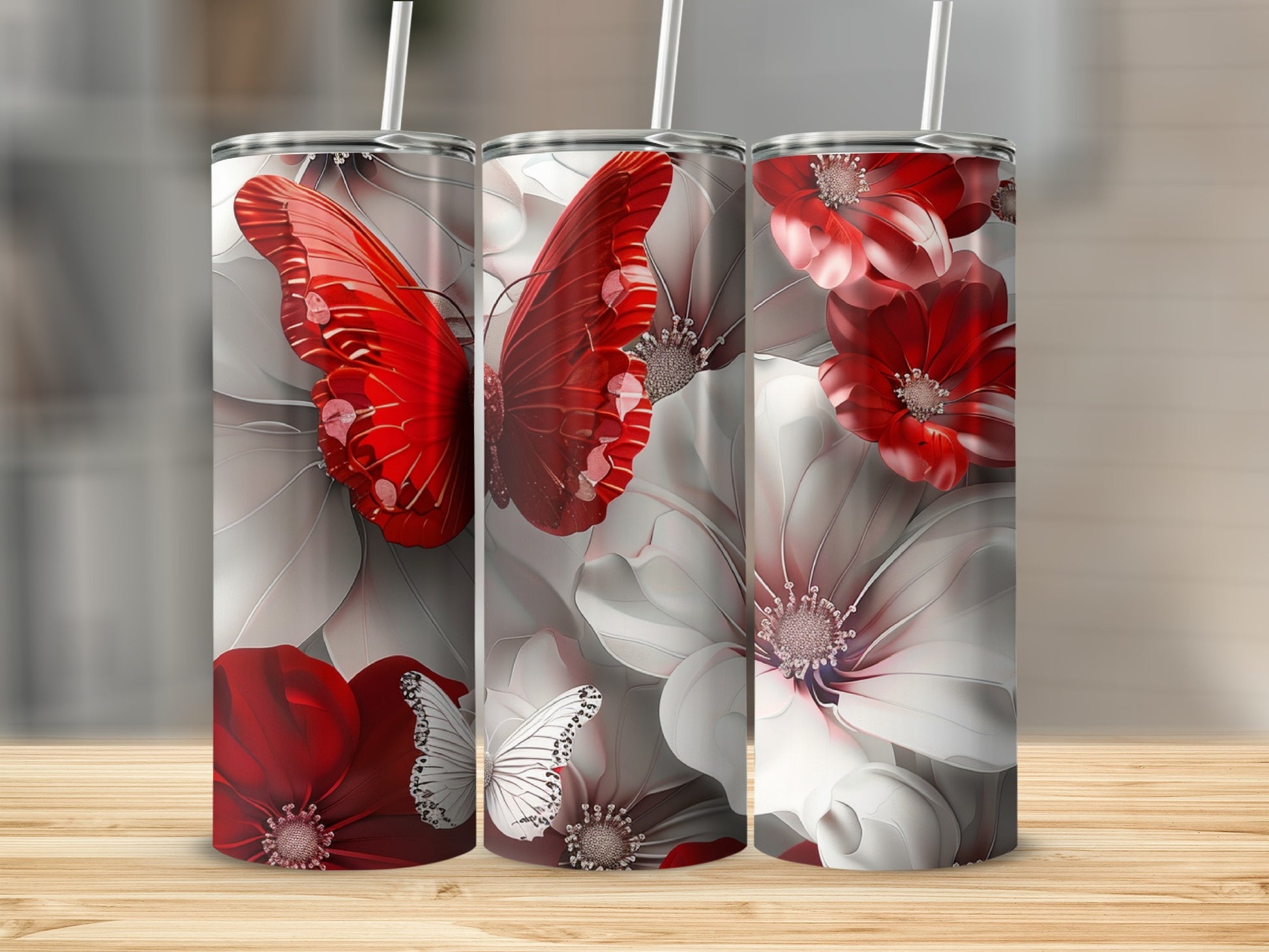 Three tumblers with red butterflies and white and red flowers.