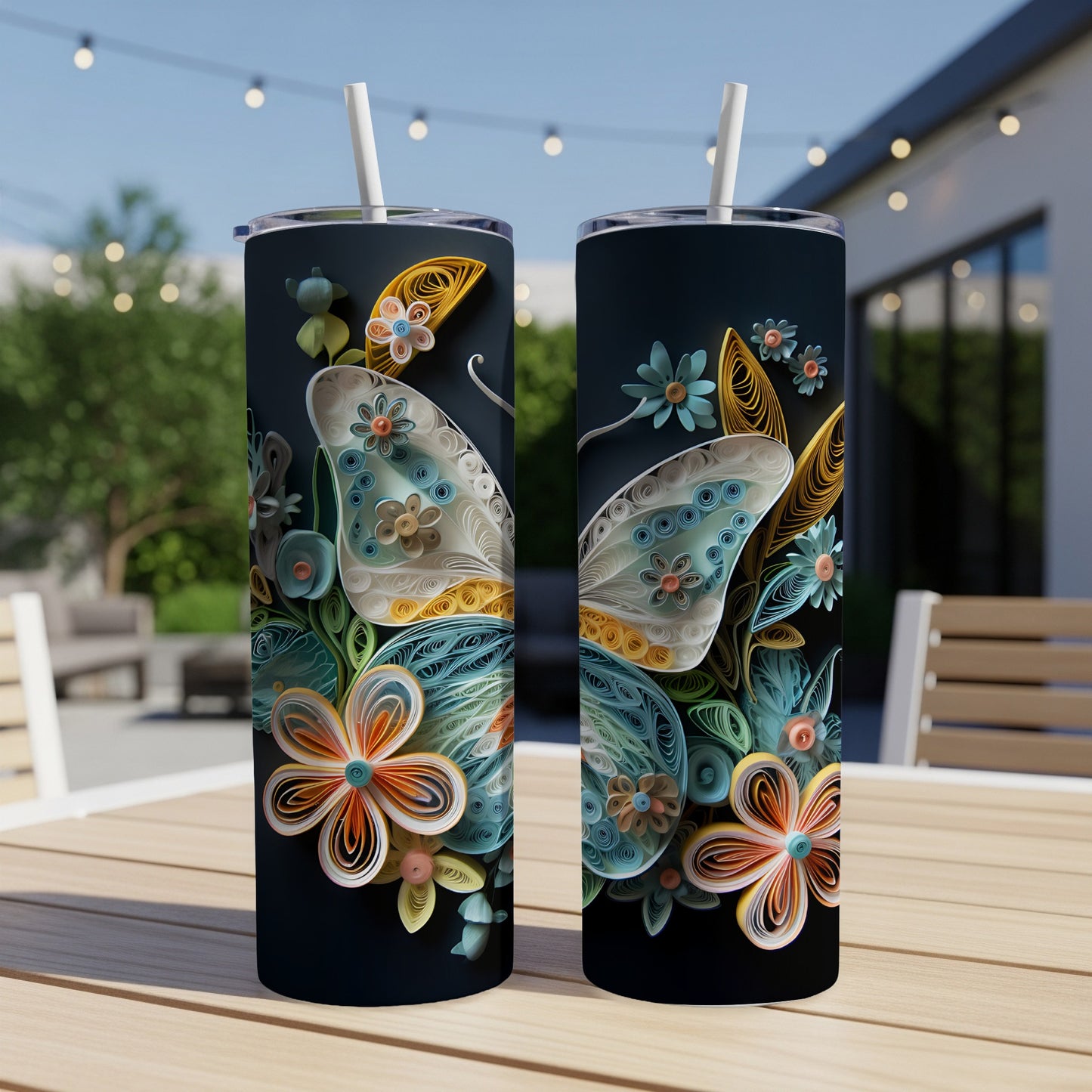 Two tumblers with intricate quilled butterfly and floral designs on a dark background.
