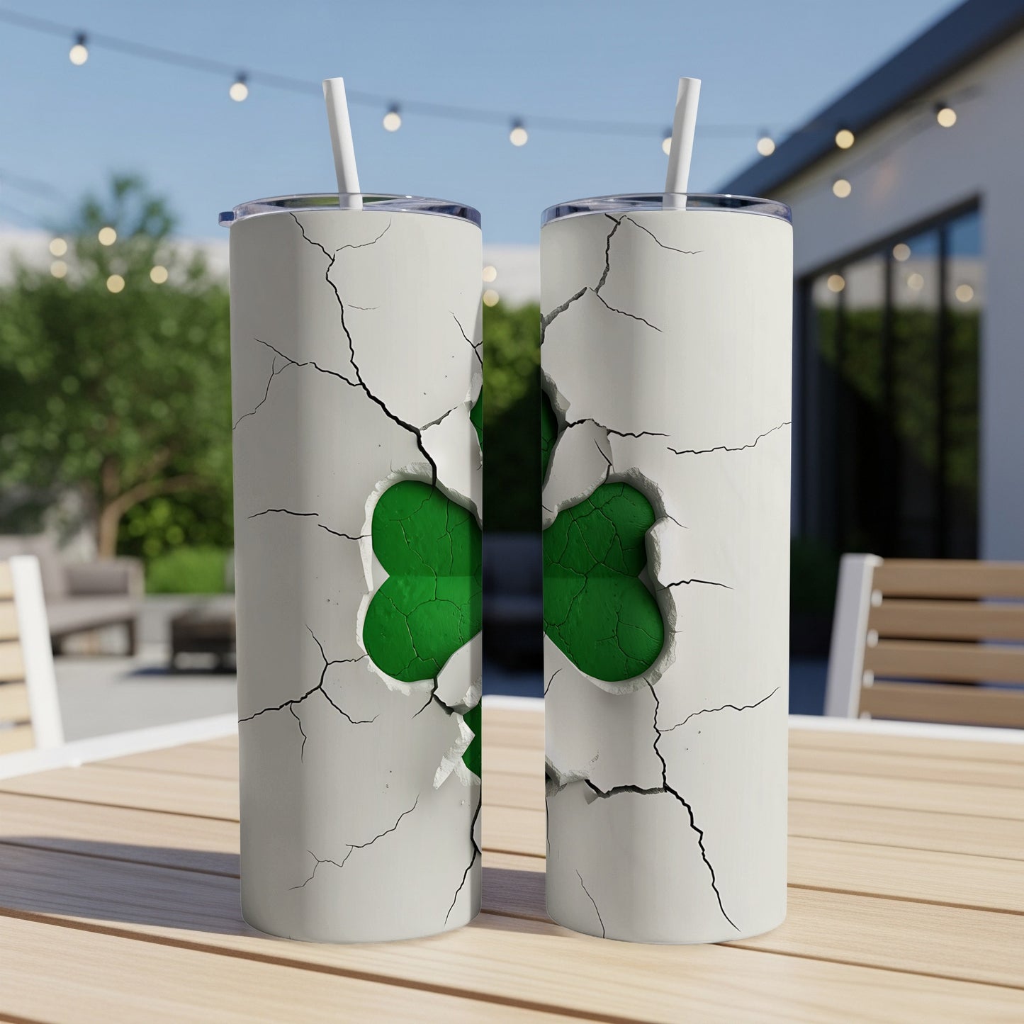 White tumbler with cracked effect revealing green shamrock design.