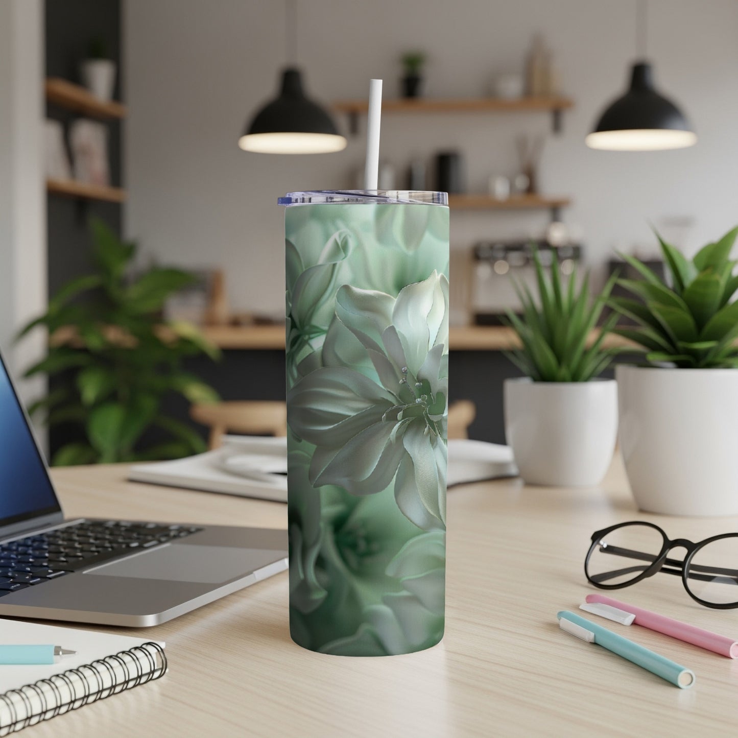 Mint green floral pattern on a skinny tumbler with a straw.