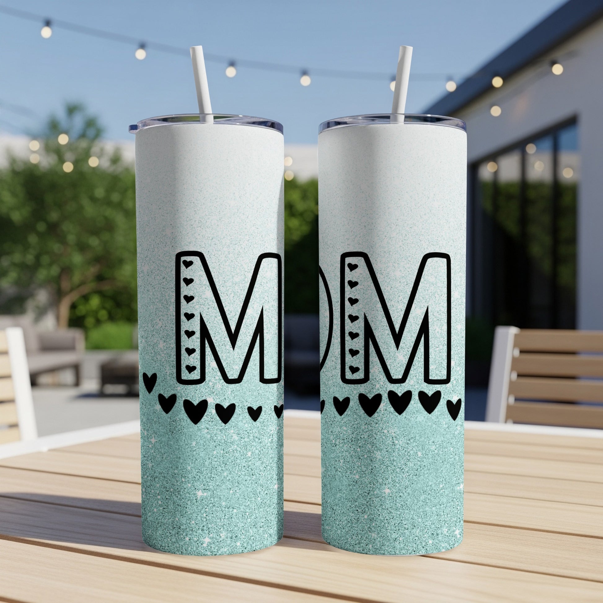 Two glittery tumblers with "MOM" and heart designs.