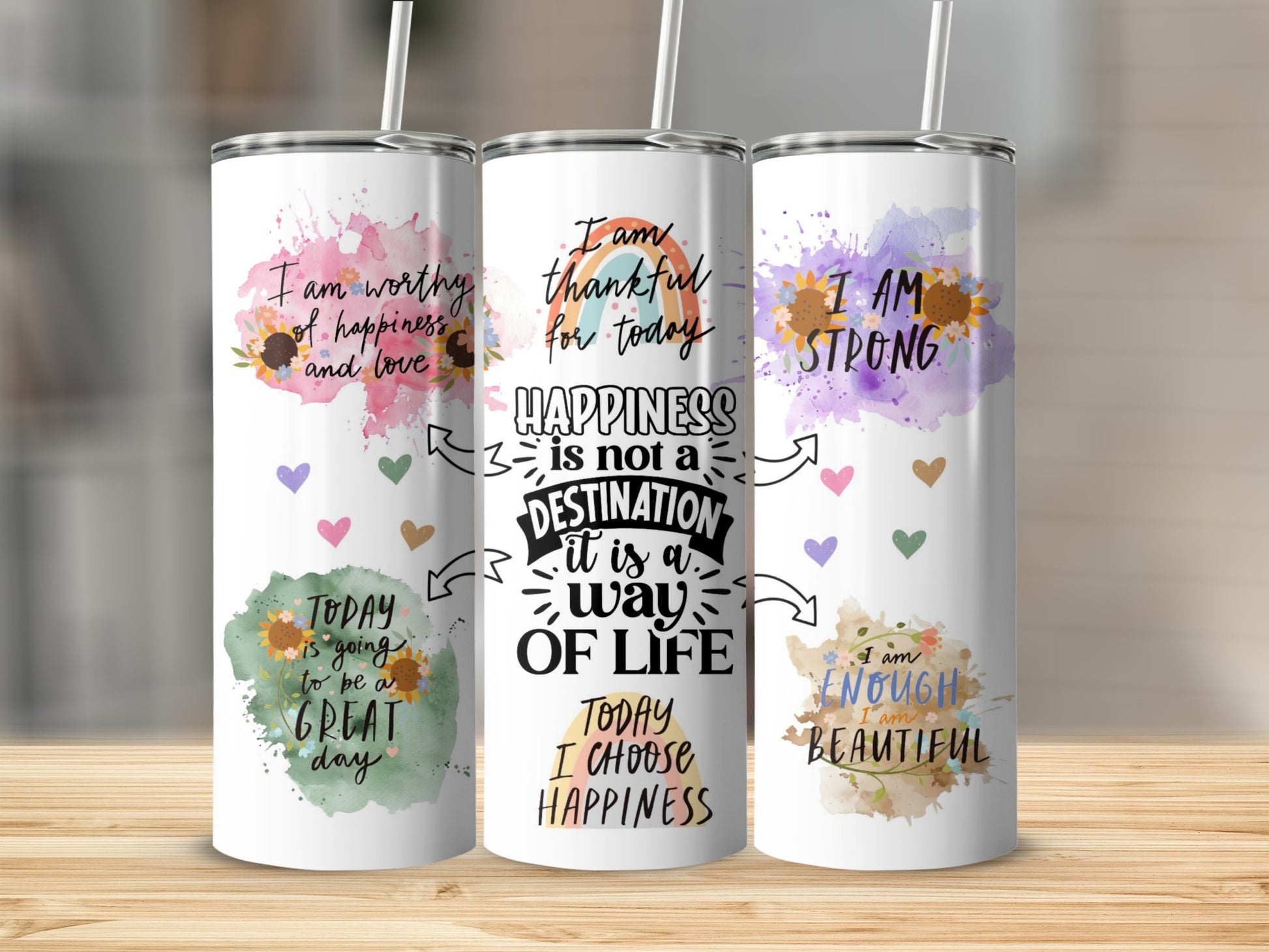 Three tumblers with inspirational quotes and watercolor floral designs.