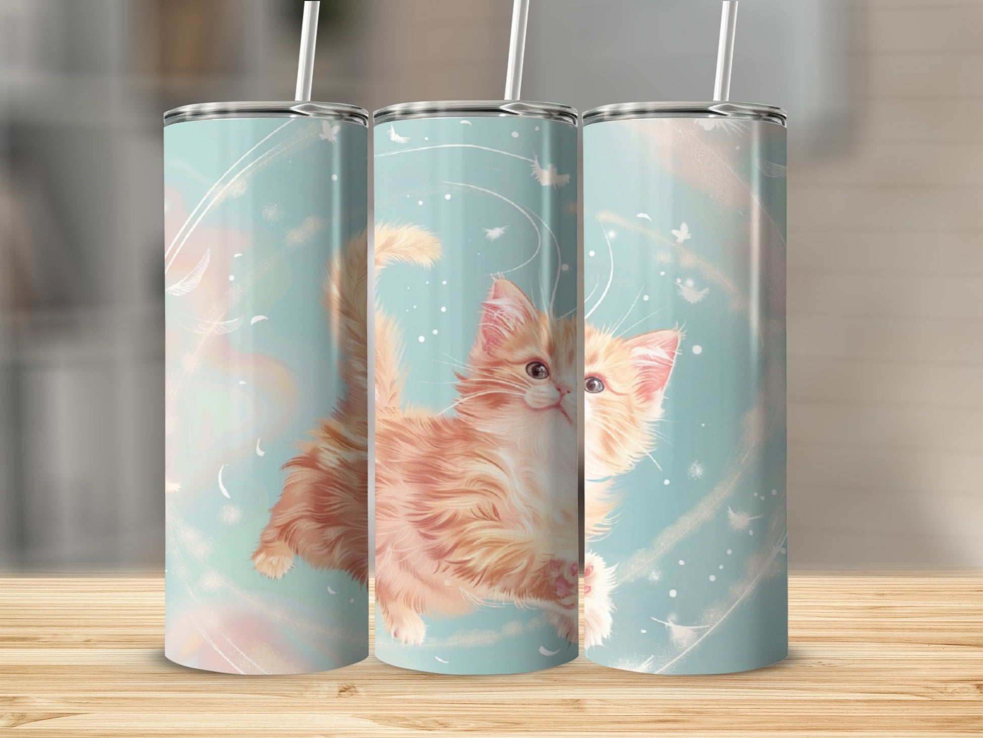 Three tumblers with a fluffy orange kitten and abstract background.