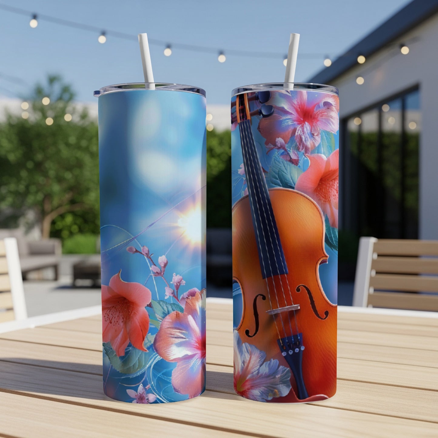 Violin and flowers design on two tall tumblers on a table.