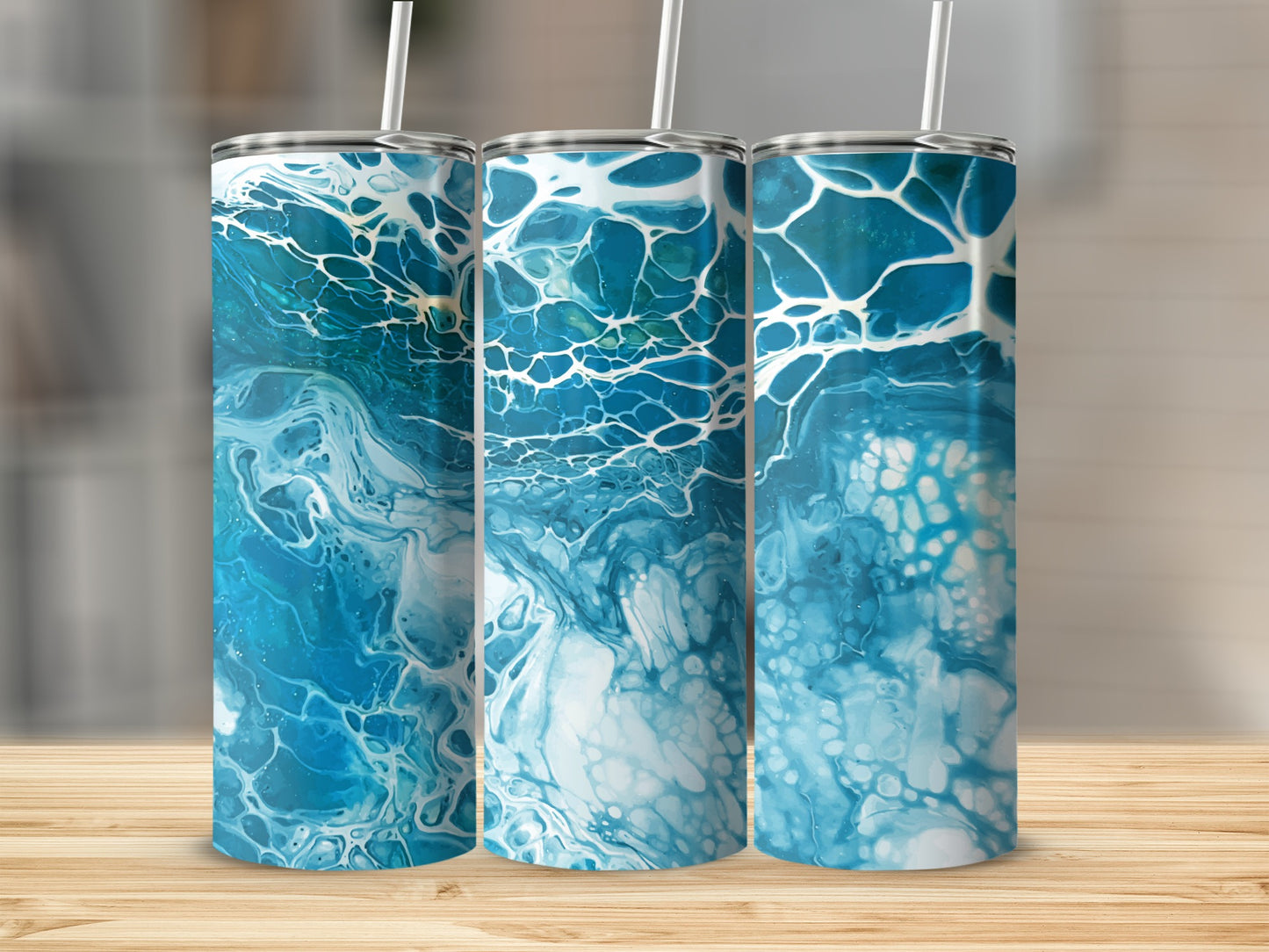 Three tumblers with abstract blue and white liquid pour art patterns.