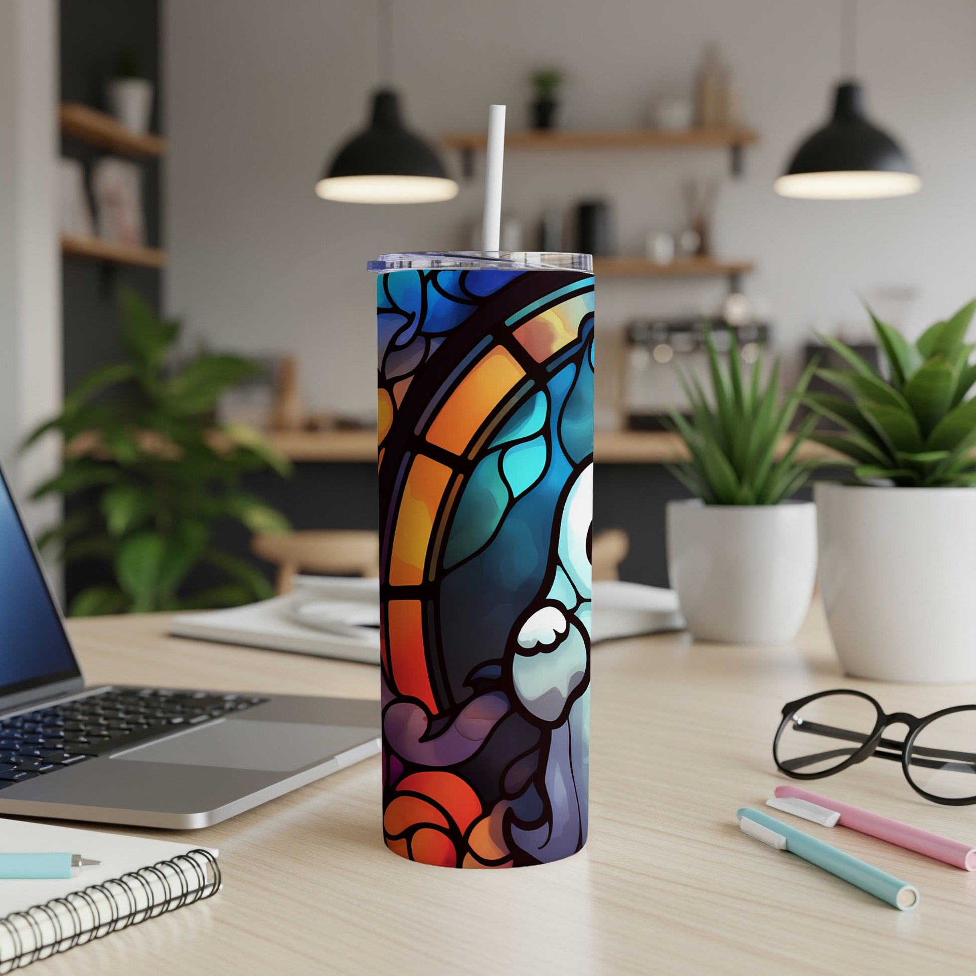 Tumbler with stained glass design of a ghost against a colorful background.