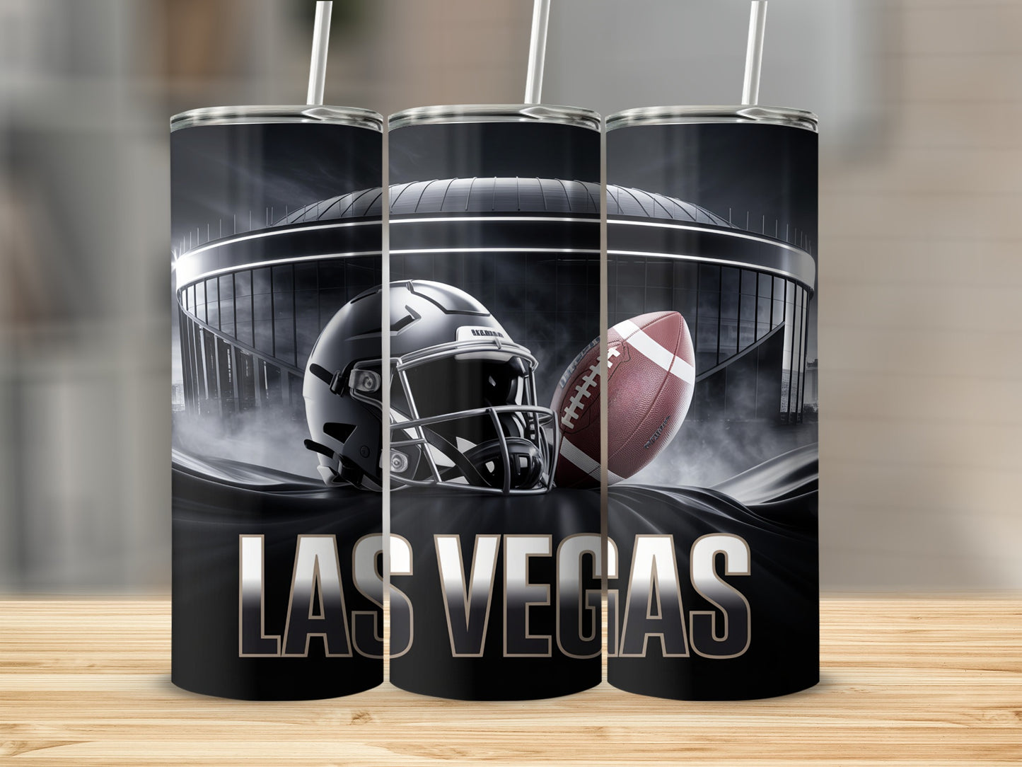 Las Vegas Raiders helmet and football in front of stadium.