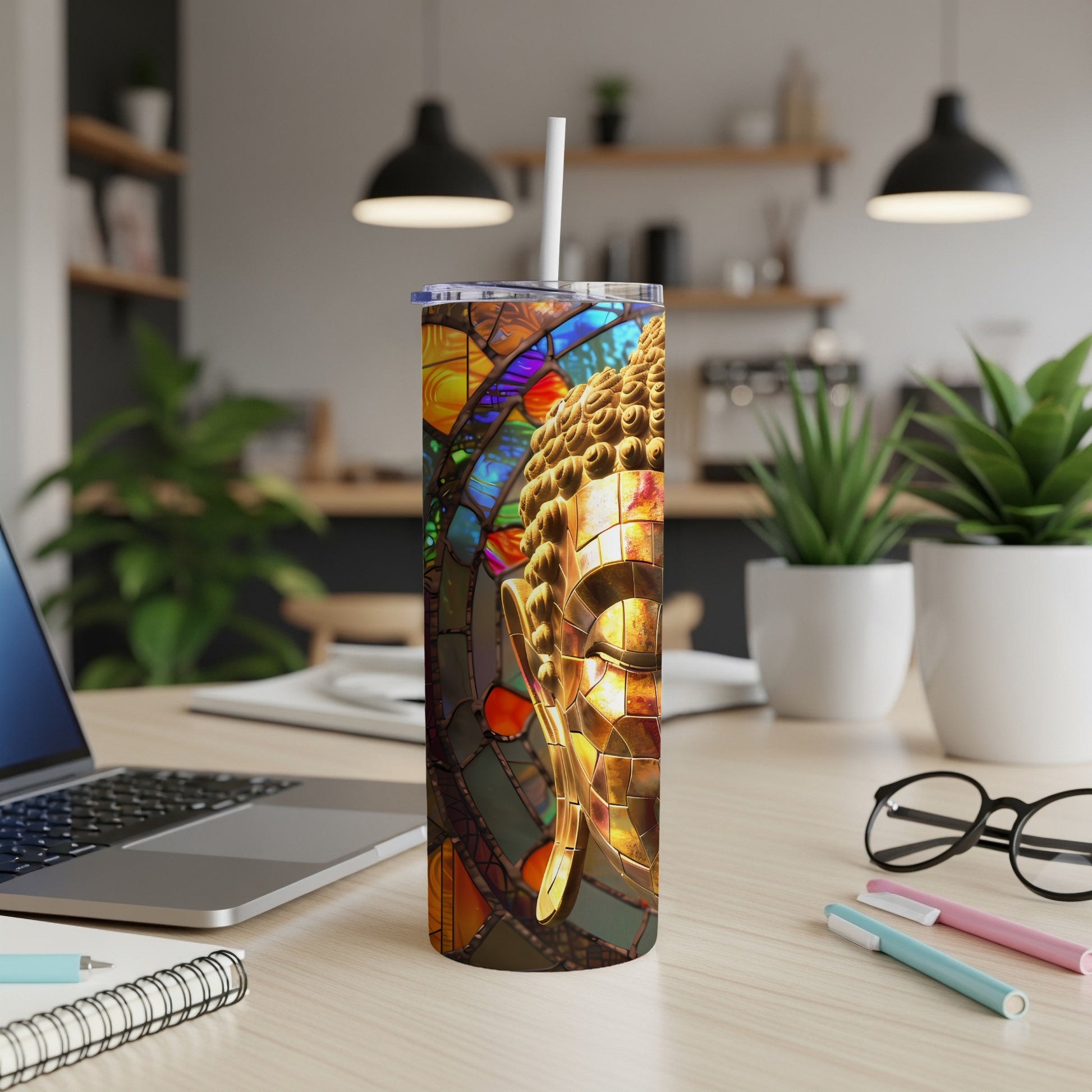 Stained glass Buddha head on a stainless steel tumbler.