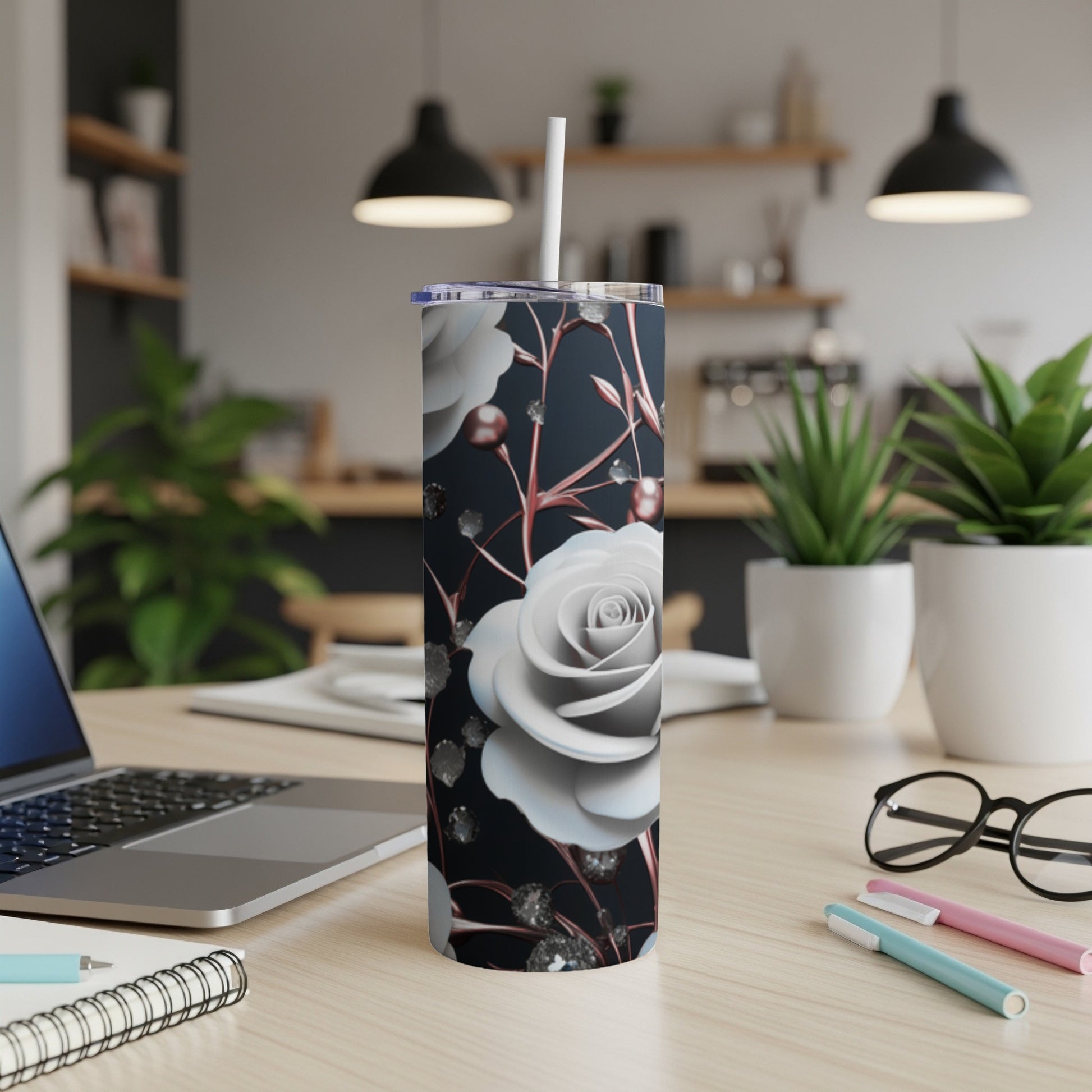 White rose tumbler with sparkling accents on a desk.