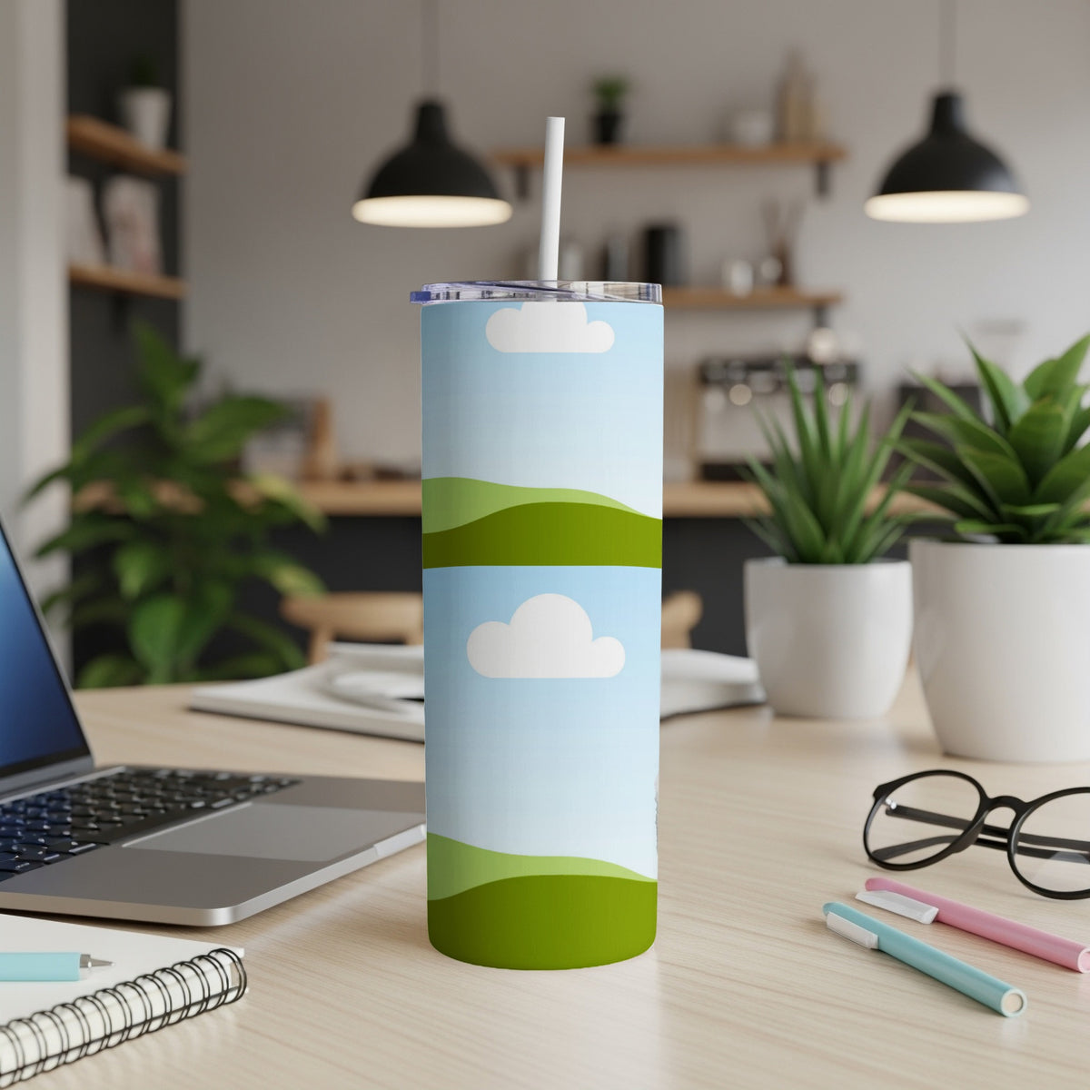 Light blue tumbler with cloud and rolling green hills design.