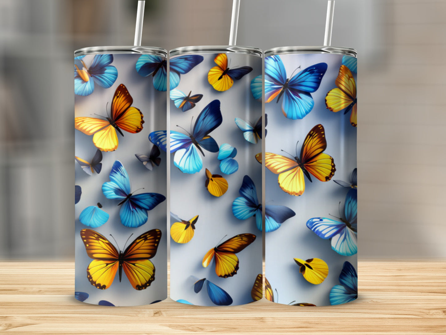 Three tumblers with colorful butterfly designs.
