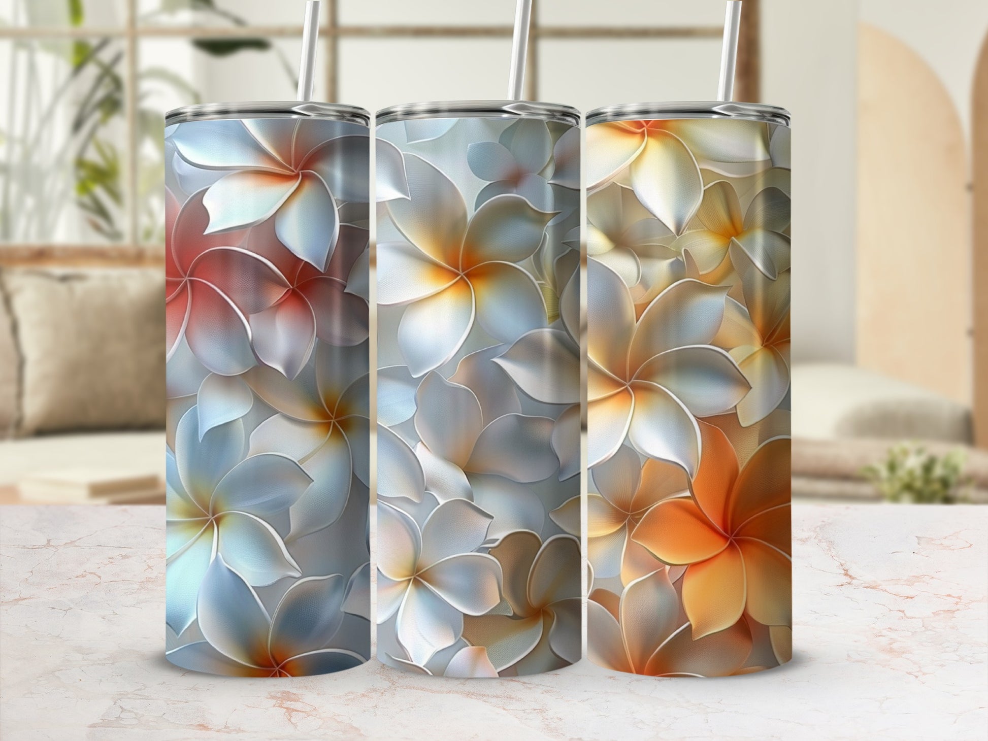Three tumblers with floral patterns in shades of blue, white, and orange.