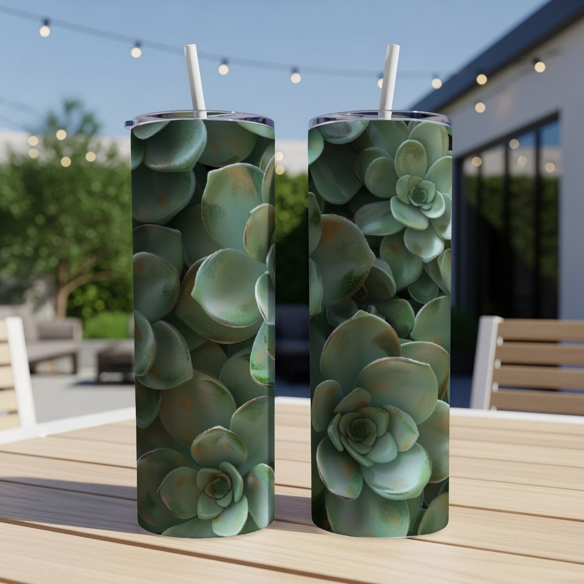 Two tumblers with close-up succulent plant design on outdoor table.