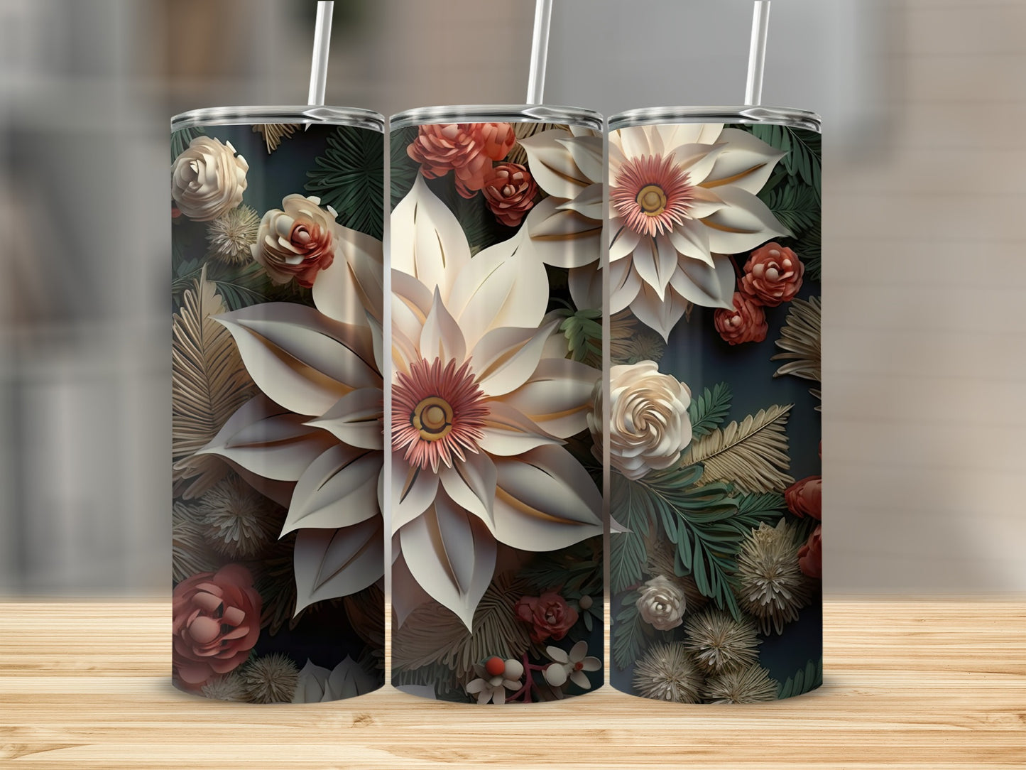 Three tumblers with floral and foliage pattern, centered on a wooden surface.