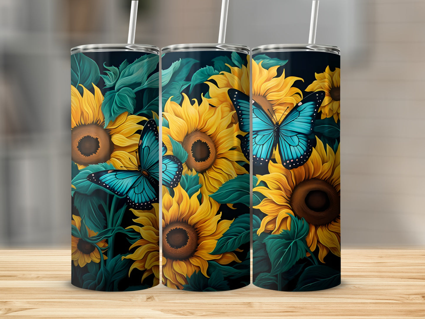 Three tumblers featuring sunflowers and blue butterflies on a dark background.