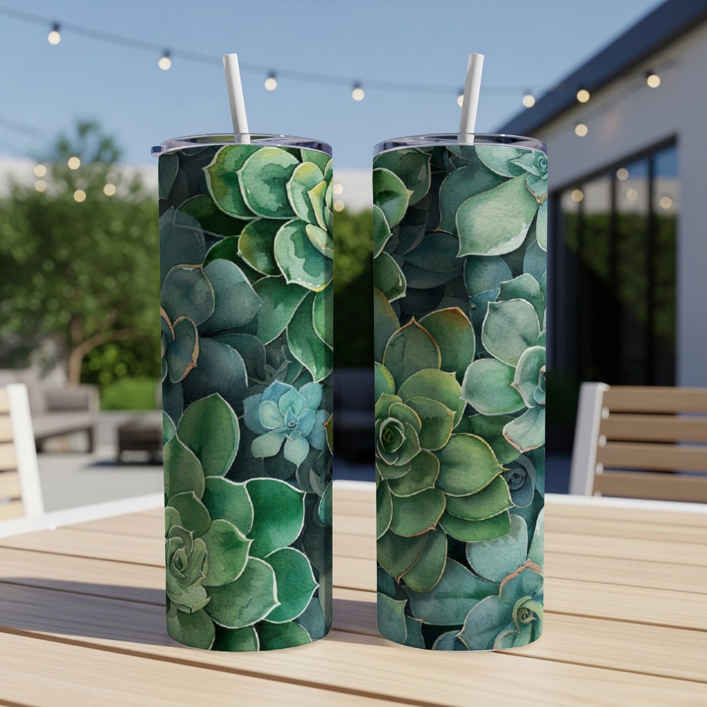Two tumblers with a green succulent plant pattern sit on a table.
