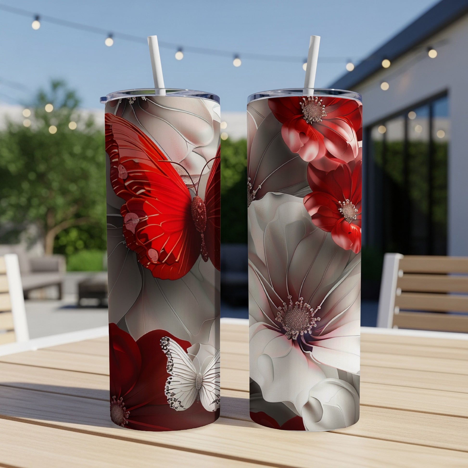 Two tumblers with red and white butterfly and floral designs.